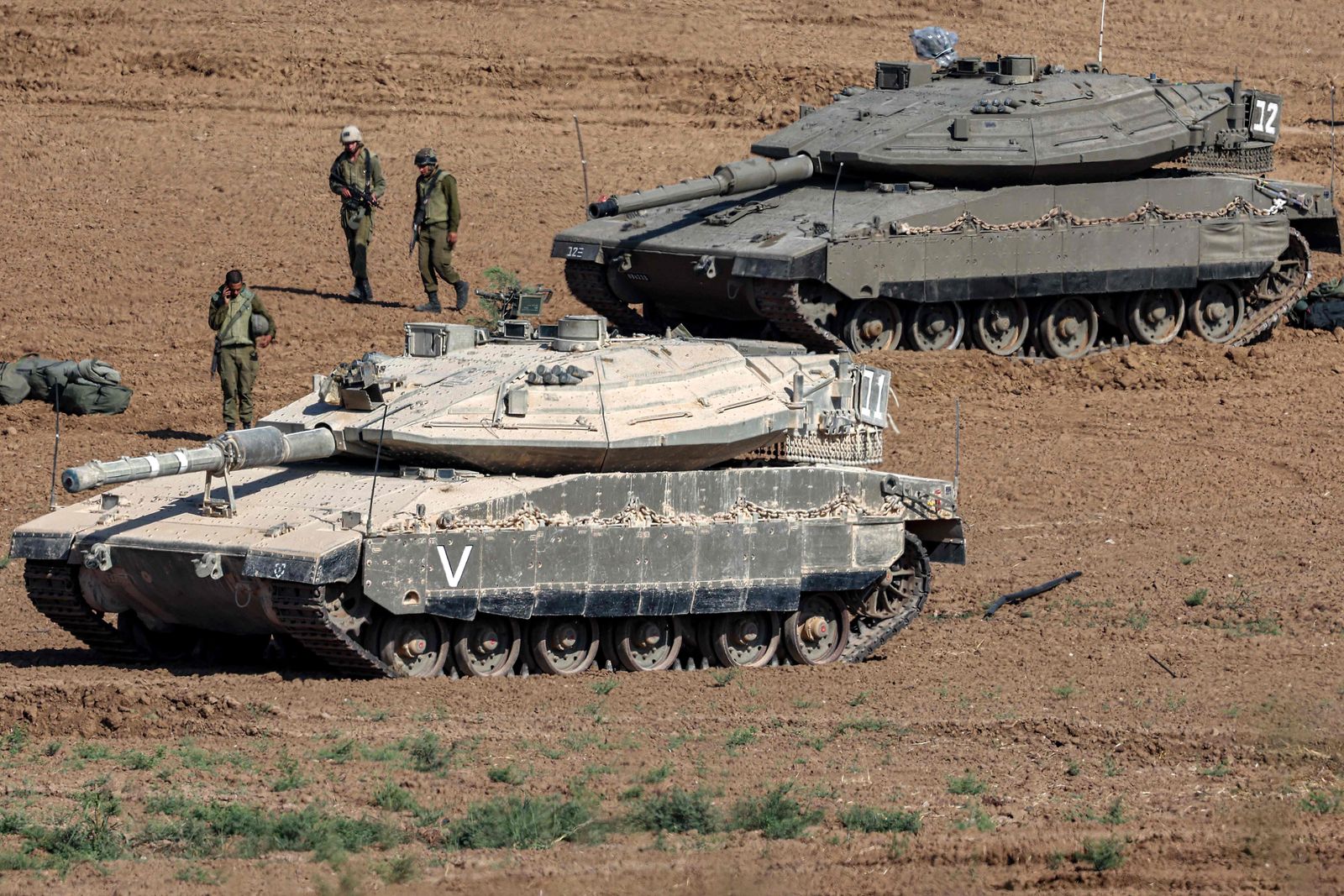 Israeli army Merkava battle tanks deploy along the border with the Gaza Strip in southern Israel on October 13, 2023. Thousands of people, both Israeli and Palestinians have died since October 7, 2023, after Palestinian Hamas militants entered Israel in a surprise attack leading Israel to declare war on Hamas in the Gaza Strip enclave on October 8. (Photo by JACK GUEZ / AFP)