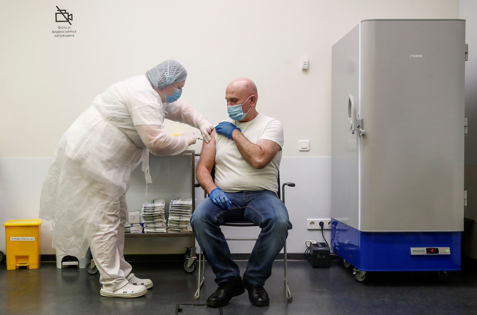 FILE PHOTO: A man receives an injection with Sputnik V (Gam-COVID-Vac) vaccine against the coronavirus disease (COVID-19) in Moscow - REUTERS