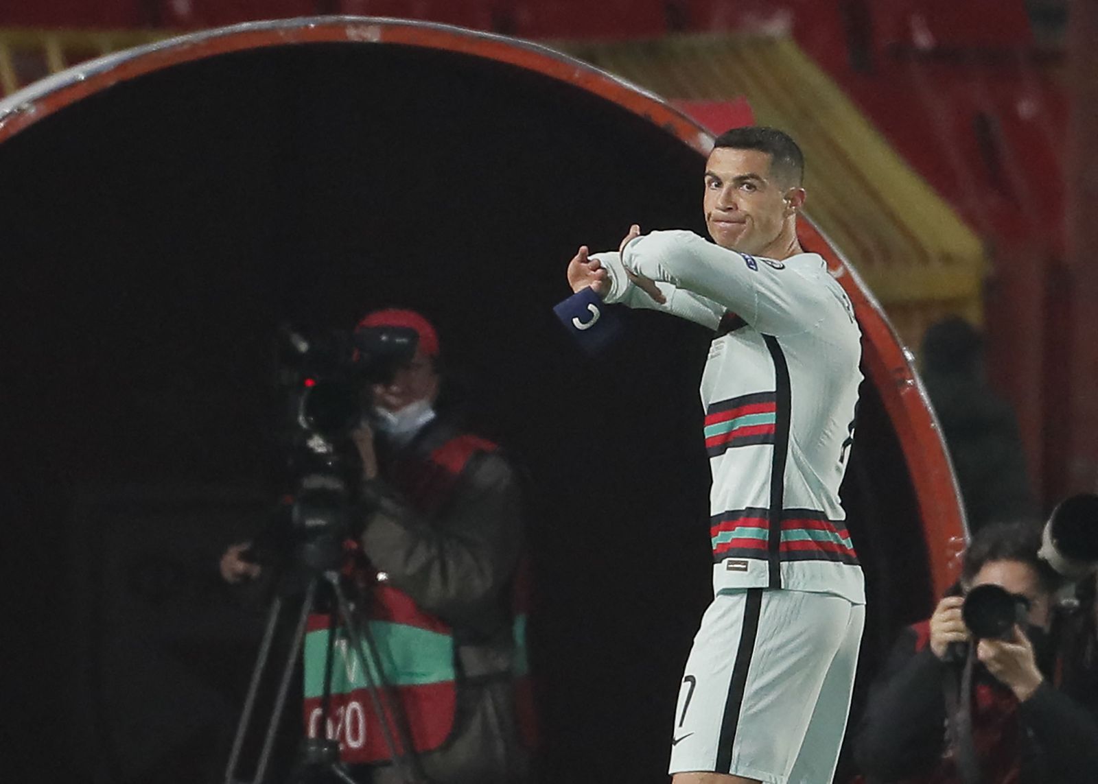 Portugal's forward Cristiano Ronaldo holds his captain armband moments before he threw it to the ground and left the pitch at the end of the FIFA World Cup Qatar 2022 qualification Group A football match between Serbia and Portugal at the Rajko Mitic Stadium, in Belgrade, on March 27, 2021. - Cristiano Ronaldo threw his captain's armband to the ground in anger after being controversially denied an injury-time winner as Portugal blew a two-goal lead against Serbia in World Cup qualifying. (Photo by pedja milosavljevic / AFP) - AFP