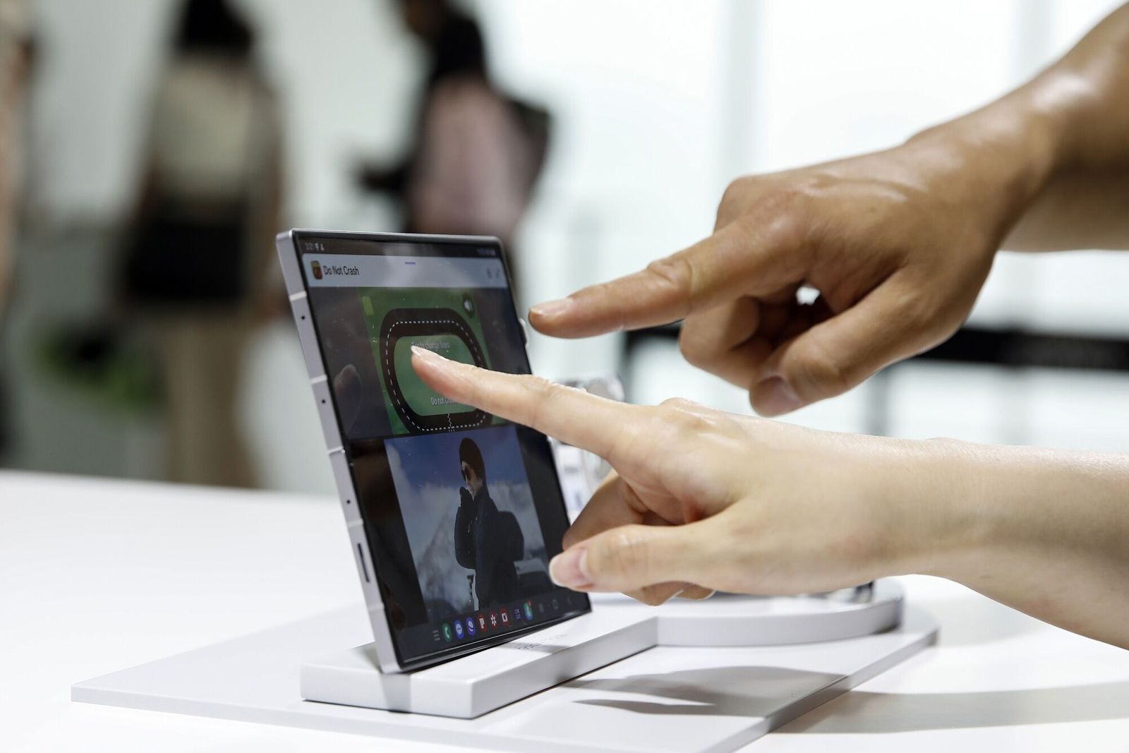 Attendants try out a Samsung Electronics Co. Galaxy Z Fold 6 smartphone at a preview of the Galaxy Unpacked event in Seoul, South Korea, on Monday, July 8, 2024. Samsung is upping its bid to rival Apple Inc. in wearables by launching a smart ring and releasing a new high-end wearable with a similar look and features as the Apple Watch Ultra. Photographer: Woohae Cho/Bloomberg