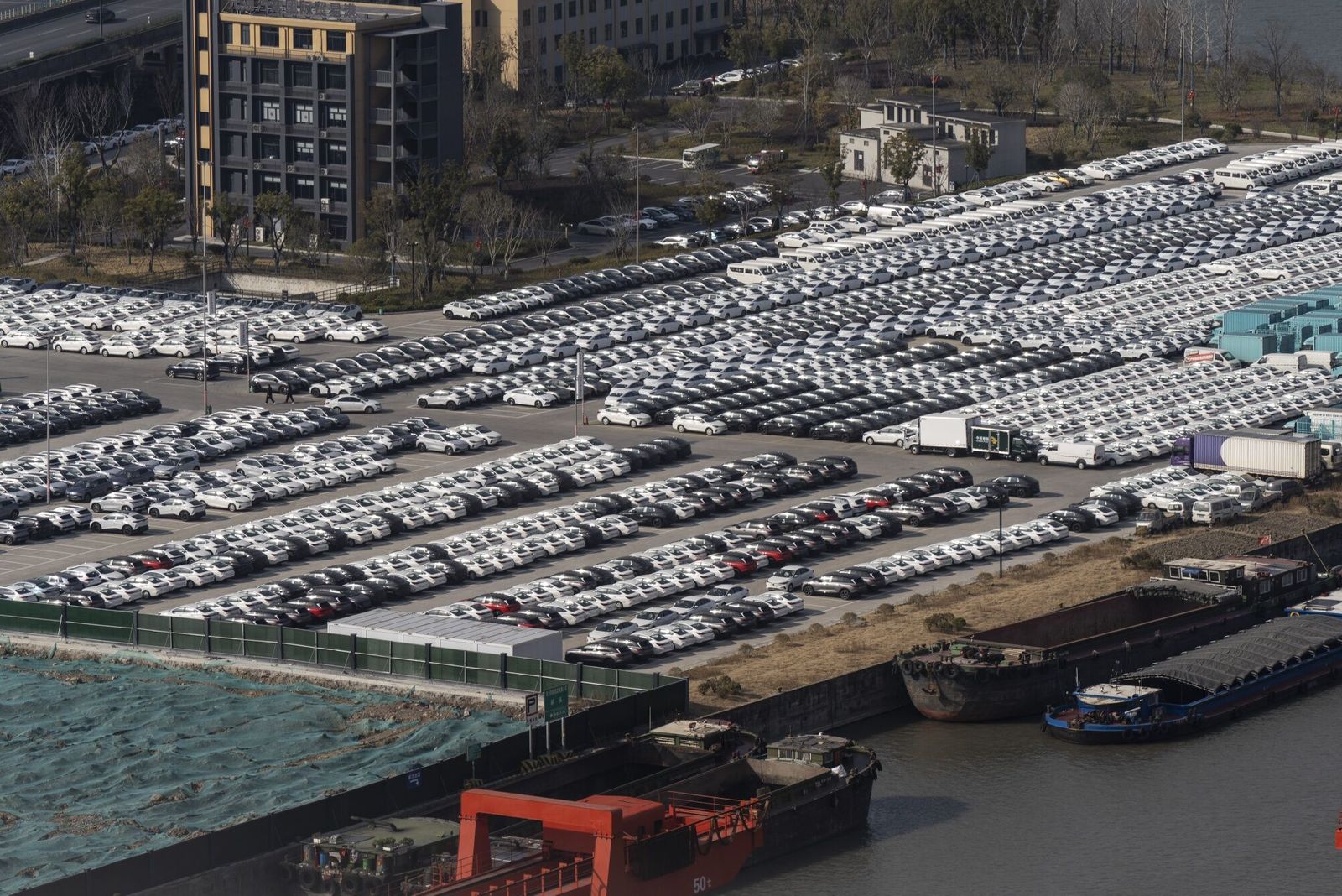 Vehicles parked in a car storage yard near a river port on the Grand Canal in Hangzhou, China, on Friday, Feb. 7, 2025. Shares related to the Chinese EV supply chain staged a strong rally this week. Photographer: Qilai Shen/Bloomberg