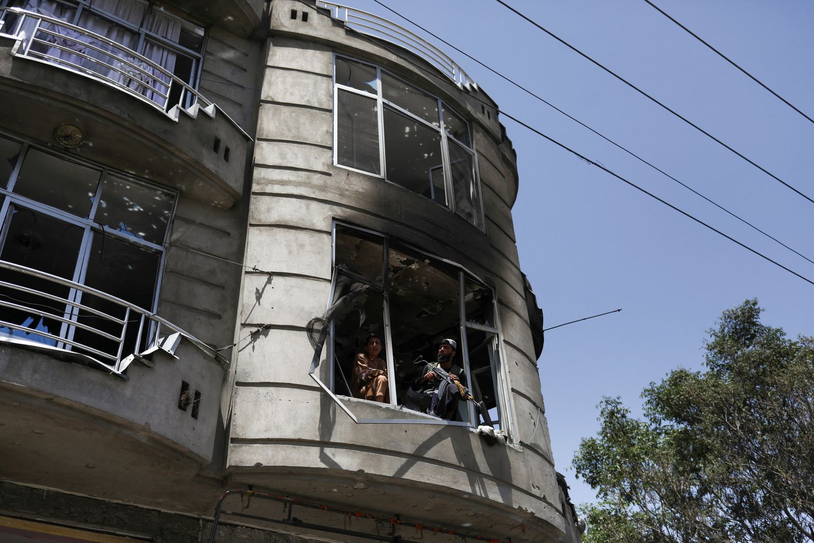 Taliban fighters stand guard at the site of explosions at Sikh Temple in Kabul - REUTERS