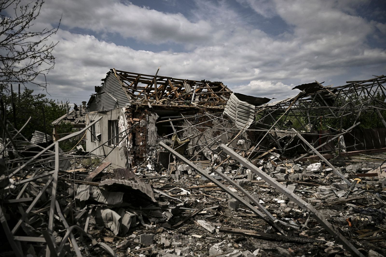 A destoyed house is seen after a missile strike in the city of Slovyansk in the eastern Ukrainian region of Donbas on June 1, 2022. (Photo by ARIS MESSINIS / AFP) - AFP