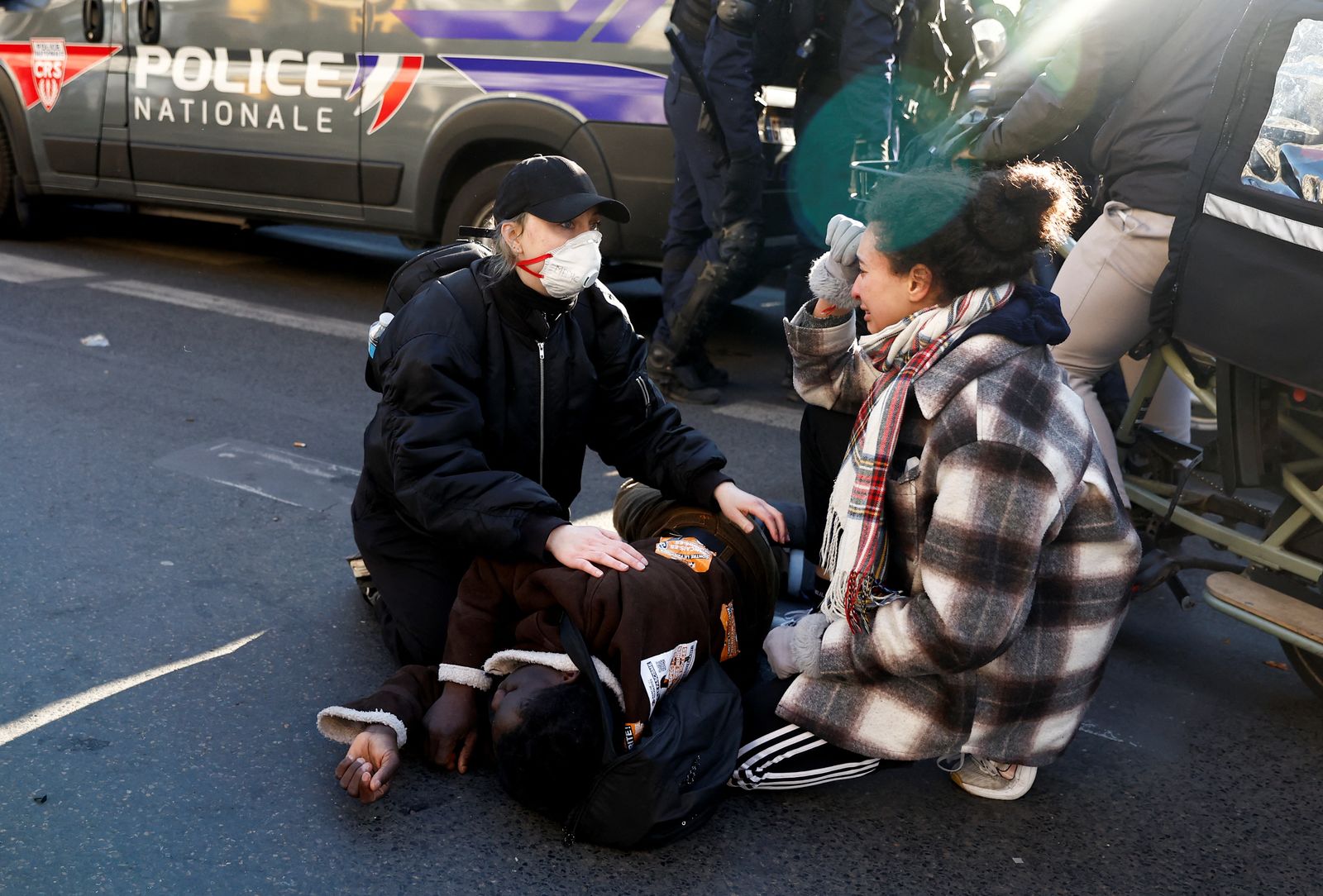 A migrant lies on the ground as police evict migrants from the Gaite Lyrique theatre after more than three months of their occupation, in Paris, France, March 18, 2025. REUTERS/Abdul Saboor