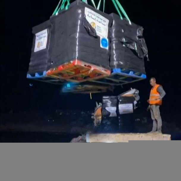 This grab taken from video footage provided by World Central Kitchen (WCK) shows members of the US charity unloading food aid for the Gaza Strip from the Open Arms vessel, onto the shore of the besieged Palestinian territory on March 15, 2024, amid ongoing battles between Israel and the militant Hamas group. WCK said its team had finished unloading almost 200 tonnes of food, the first shipment to reach Gaza through a new maritime aid corridor from Cyprus. (Photo by WORLD CENTRAL KITCHEN / AFP) / RESTRICTED TO EDITORIAL USE - MANDATORY CREDIT 'AFP PHOTO/WORLD CENTRAL KITCHEN (WCK)' - NO MARKETING NO ADVERTISING CAMPAIGNS - DISTRIBUTED AS A SERVICE TO CLIENTS