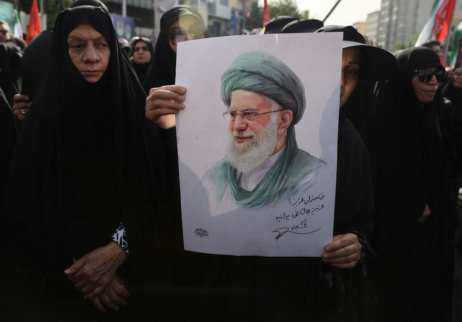 A woman holds a picture of Iran's Supreme Leader Ayatollah Ali Khamenei as she attends the funeral procession of Iranian military commanders and nuclear scientists killed in Israeli strikes, in Tehran, Iran, June 28, 2025. Majid Asgaripour/WANA (West Asia News Agency) via REUTERS   ATTENTION EDITORS - THIS PICTURE WAS PROVIDED BY A THIRD PARTY