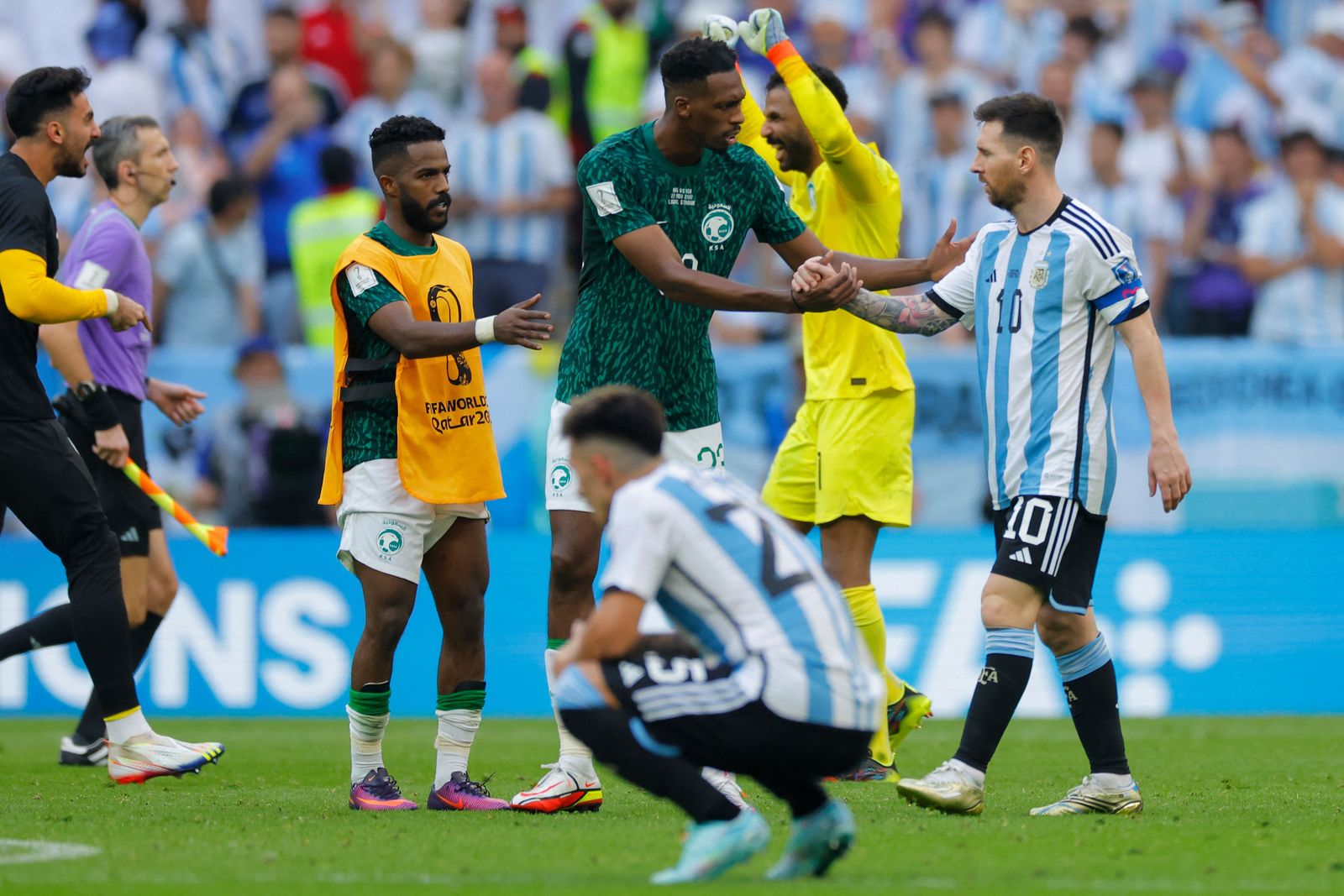 Saudi Arabia's midfielder #23 Mohamed Kanno shakes hands with Argentina's forward #10 Lionel Messi after the Qatar 2022 World Cup Group C football match between Argentina and Saudi Arabia at the Lusail Stadium in Lusail, north of Doha on November 22, 2022. (Photo by Odd ANDERSEN / AFP) - AFP