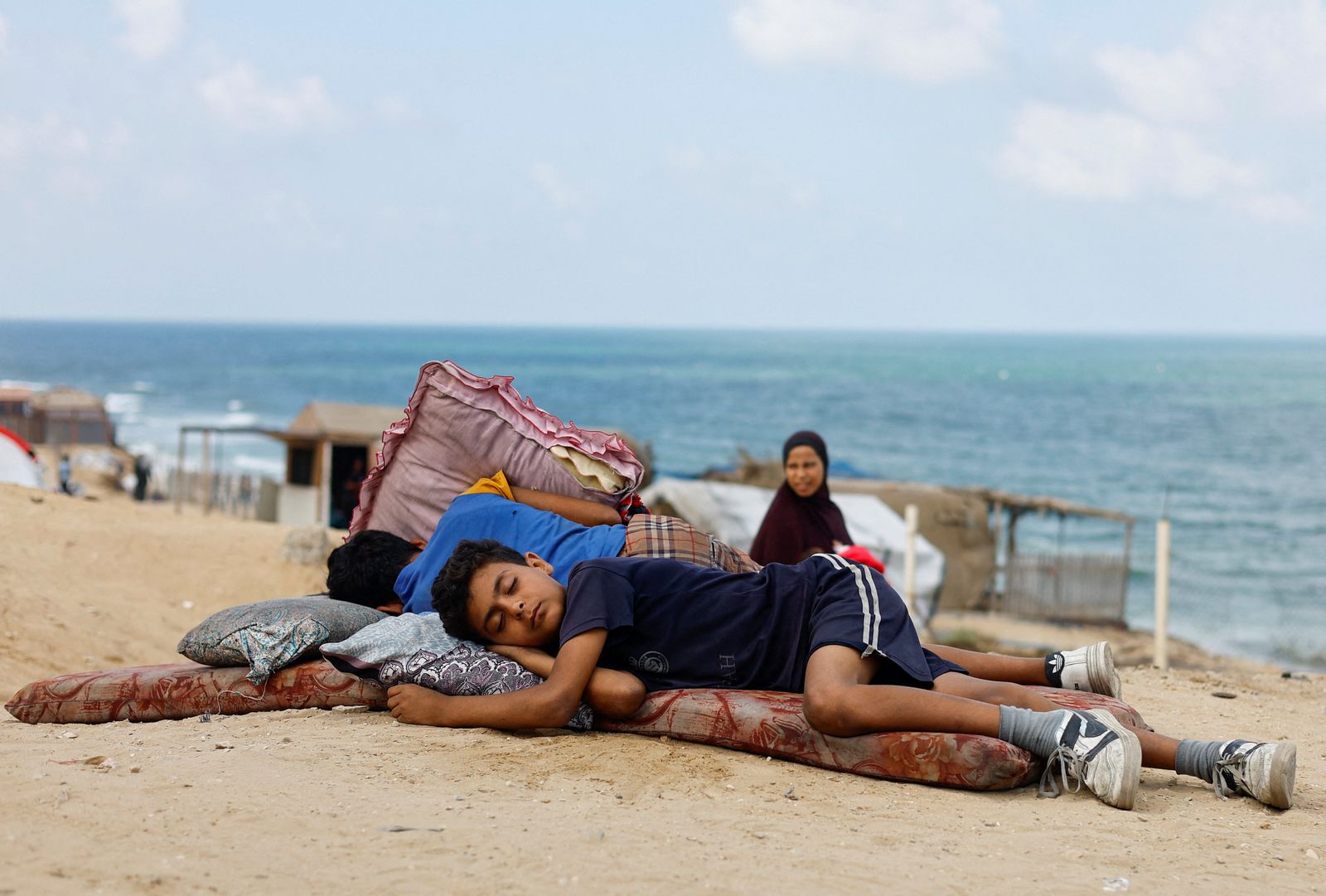 Displaced Palestinian children fleeing northern Gaza due to an Israeli military operation rest as they move southward after Israeli forces ordered residents of Gaza City to evacuate to the south, in the central Gaza Strip, September 19, 2025. REUTERS/Mahmoud Issa