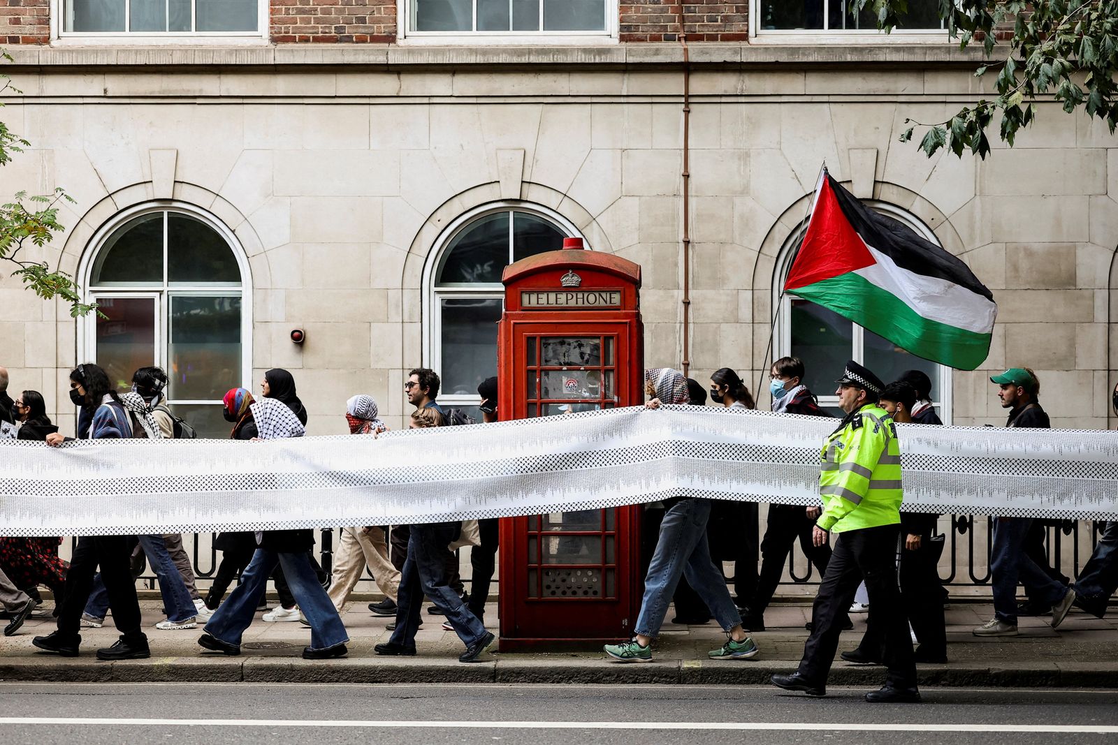 Students hold a banner listing some of the tens of thousands of civilians that pro-Palestinian protesters say have been killed in Gaza by Israel over the past two years, during an inter-university march in support of Palestinians, on the second anniversary of the deadly October 7, 2023 attack on Israel by Hamas from Gaza, in London, Britain, October 7, 2025. REUTERS/Toby Melville     TPX IMAGES OF THE DAY