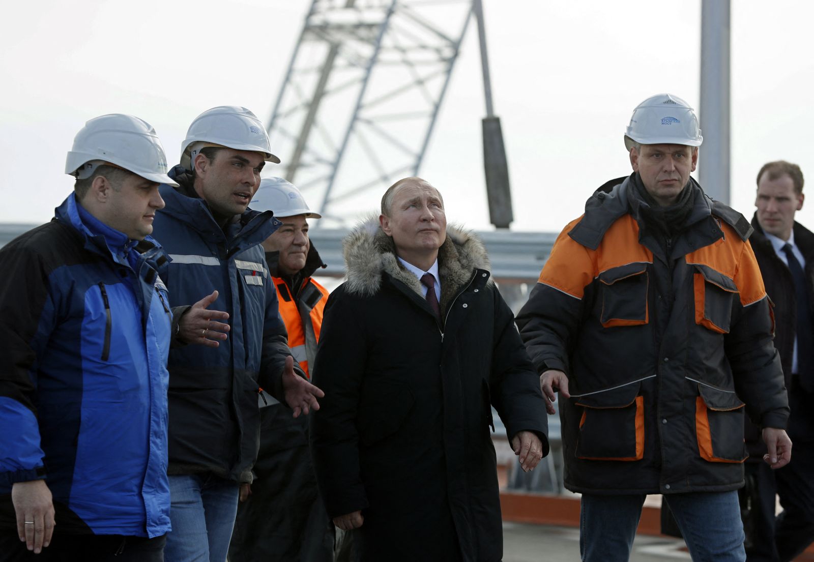 (FILES) In this file photo taken on March 14, 2018 Russian President Vladimir Putin (C) inspects the road section of the road-and-rail Crimean Bridge over the Kerch Strait. - A huge fire that broke out Saturday on a key road and rail bridge linking Crimea to Russia was caused by a car bomb, reports citing Russia's national anti-terrorism committee said on October 8, 2022. (Photo by YURI KOCHETKOV / POOL / AFP) - AFP