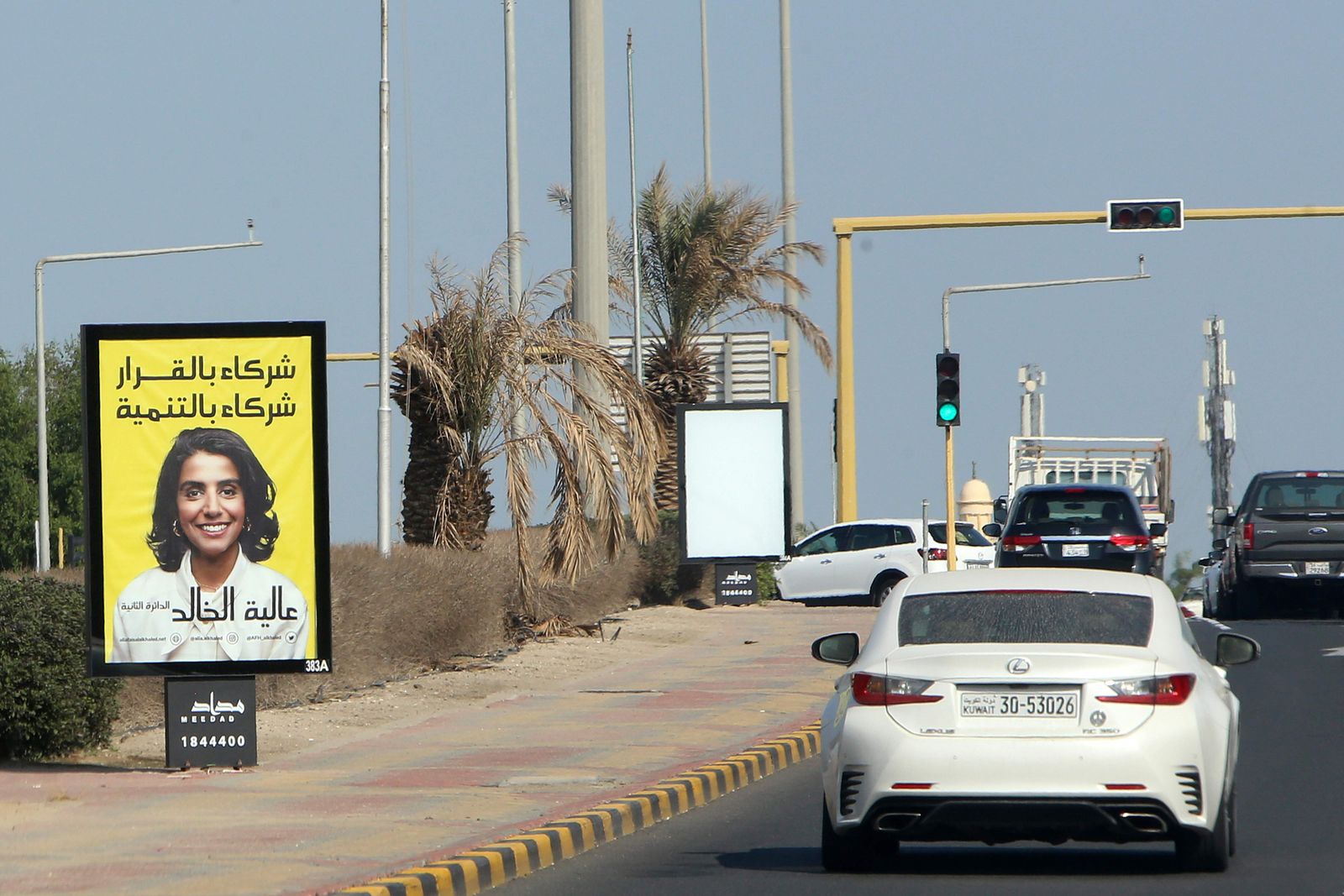 A billboard featuring a candidate running for Kuwait's parliamentary elections is seen in Kuwait city, on November 22, 2020. (Photo by YASSER AL-ZAYYAT / AFP) - AFP