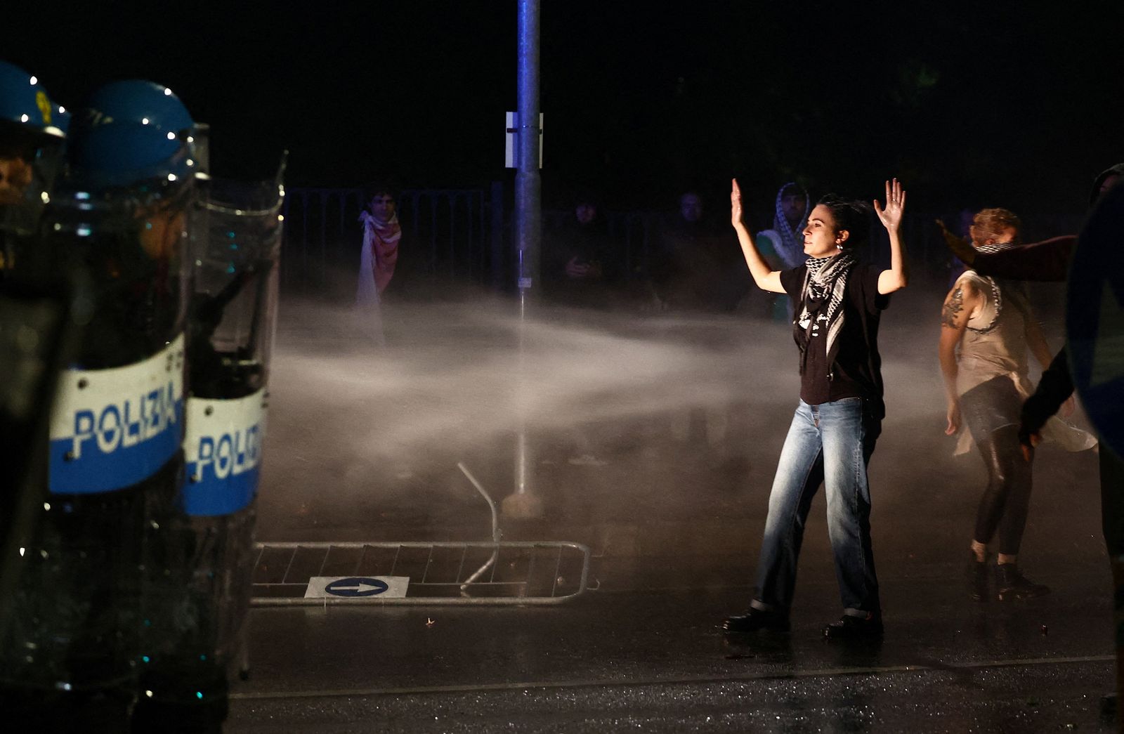 Soccer Football - FIFA World Cup - UEFA Qualifiers - Protesters rally against the Israeli national team - Udine, Italy - October 14, 2025 Police officers in riot gear are seen as a water cannon is used on Protesters as they march against the Israeli football team during a pro-Palestinian demonstration ahead of the Italy v Israel match REUTERS/Yara Nardi     TPX IMAGES OF THE DAY