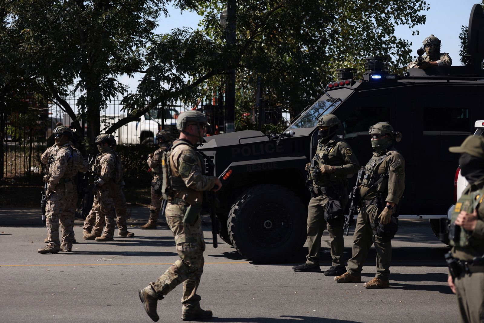 Law enforcement officers stand guard during a standoff with U.S. Immigration and Customs Enforcement (ICE) and federal officers in the Little Village neighborhood of Chicago, Illinois, U.S., October 4, 2025. REUTERS/Jim Vondruska