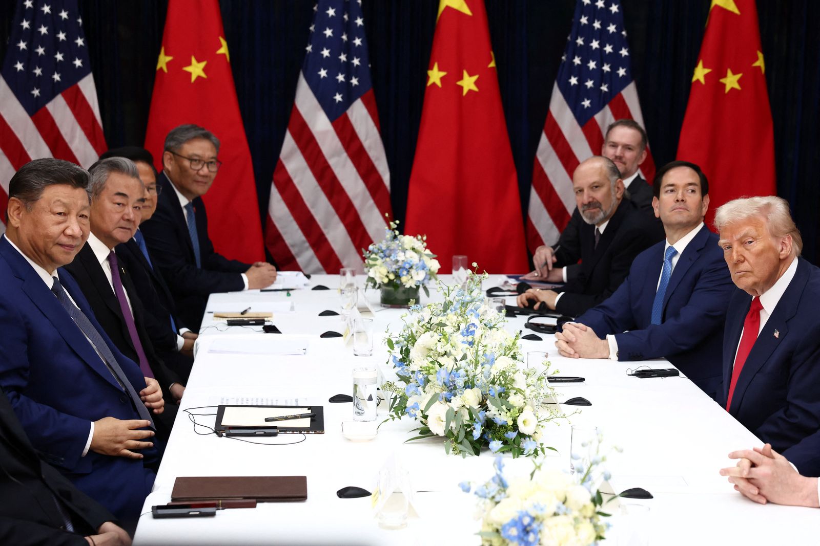 U.S. President Donald Trump, accompanied by U.S. Secretary of State Marco Rubio and U.S. Secretary of Commerce Howard Lutnick, attends a bilateral meeting with Chinese President Xi Jinping, accompanied by Chinese Foreign Minister Wang Yi, at Gimhae International Airport, on the sidelines of the Asia-Pacific Economic Cooperation (APEC) summit, in Busan, South Korea, October 30, 2025. REUTERS/Evelyn Hockstein