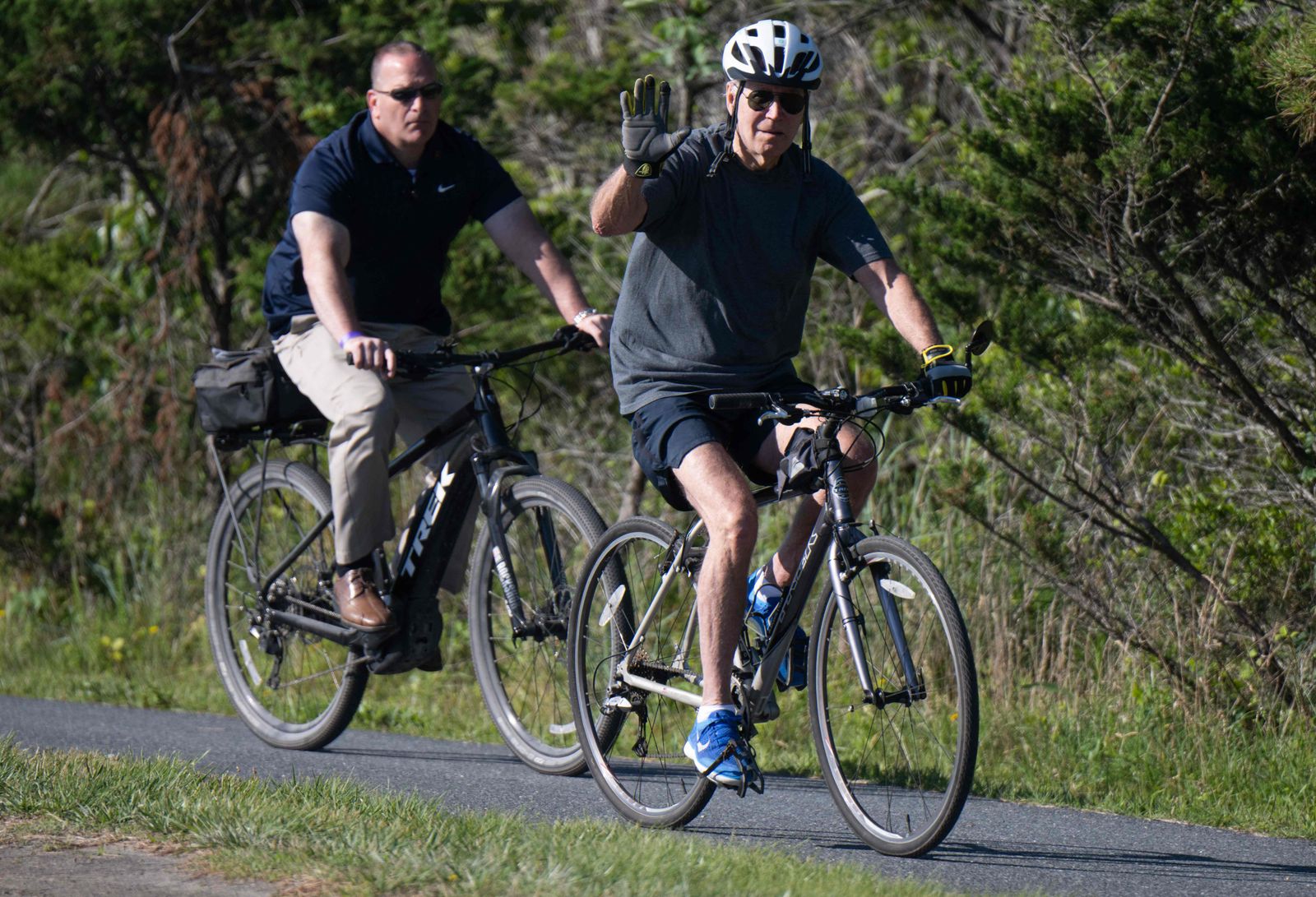 US President Joe Biden rides his bicycle at Gordon's Pond State Park in Rehoboth Beach, Delaware, on June 18, 2022. (Photo by SAUL LOEB / AFP) - AFP