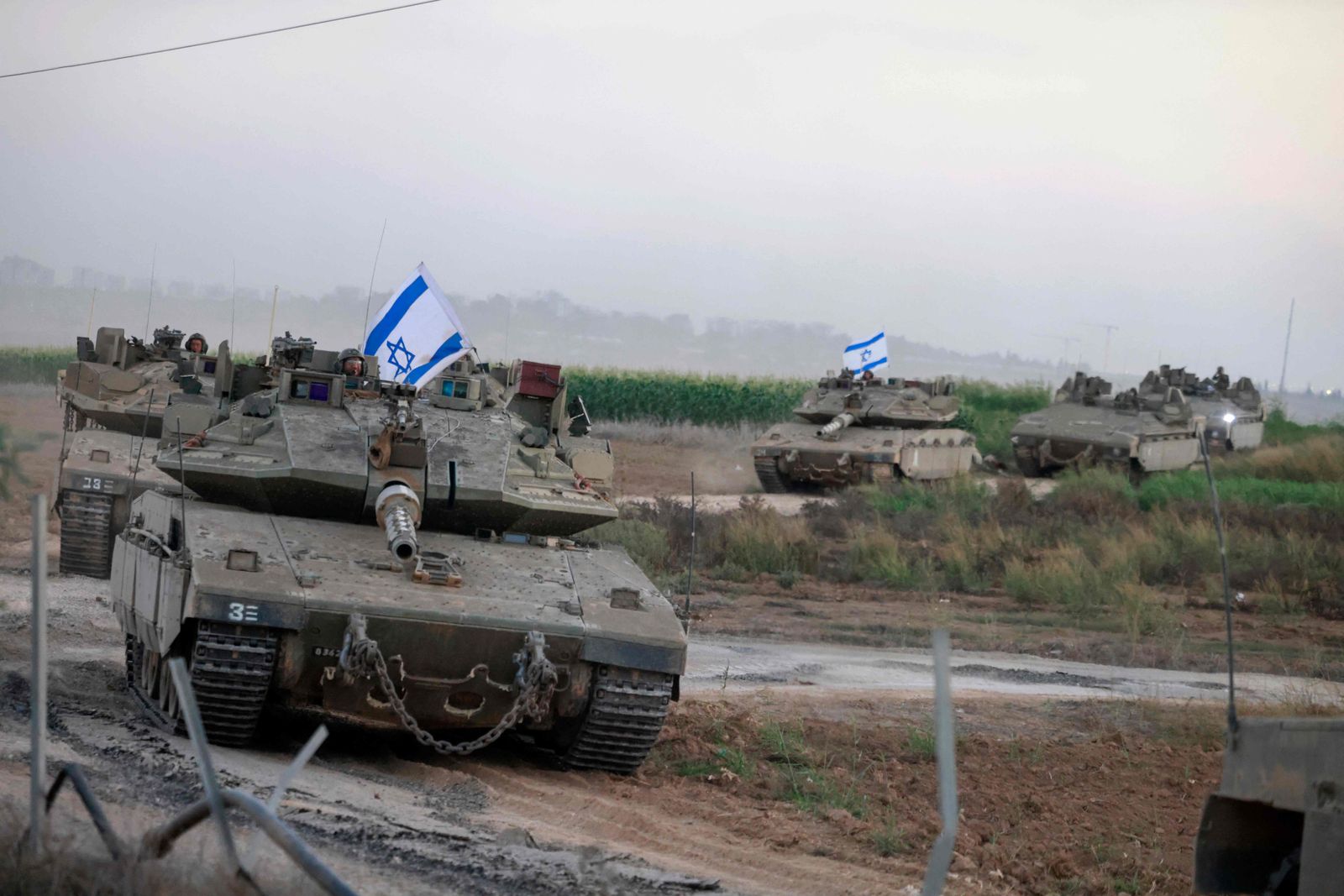 A convoy of Israeli tanks advances near the border with Gaza on October 12, 2023. Thousands of people, both Israeli and Palestinian, have died since October 7, after Palestinian Hamas militants entered Israel in a surprise attack leading Israel to declare war on Hamas in the Gaza Strip enclave. (Photo by Menahem KAHANA / AFP)