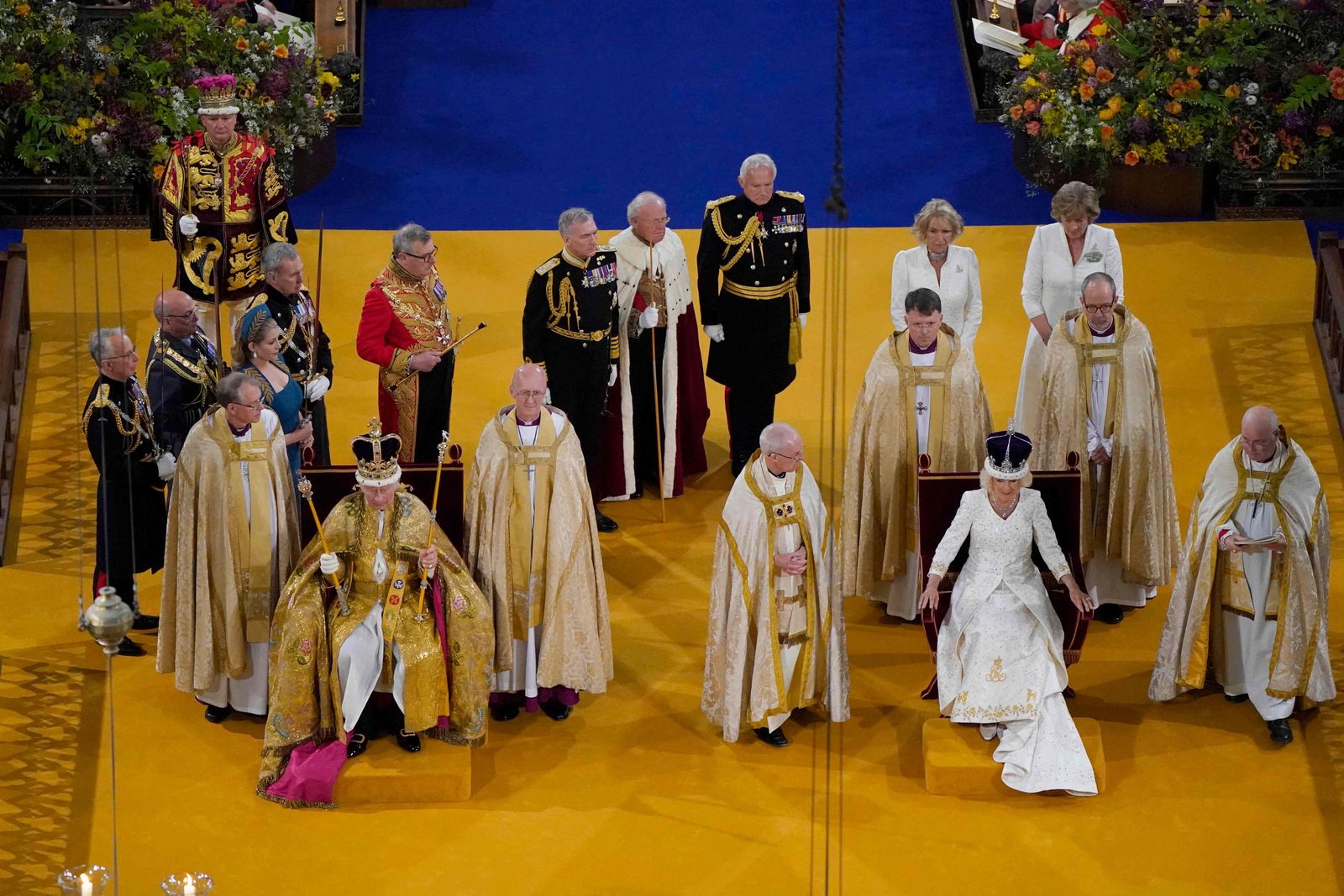 Britain's King Charles III (L) wears the St Edward's Crown on his head as Britain's Camilla wears a modified version of Queen Mary's Crown during the Coronation Ceremony inside Westminster Abbey in central London on May 6, 2023. - The set-piece coronation is the first in Britain in 70 years, and only the second in history to be televised. Charles will be the 40th reigning monarch to be crowned at the central London church since King William I in 1066. Outside the UK, he is also king of 14 other Commonwealth countries, including Australia, Canada and New Zealand. Camilla, his second wife, will be crowned queen alongside him and be known as Queen Camilla after the ceremony. (Photo by Andrew Matthews / POOL / AFP) - AFP