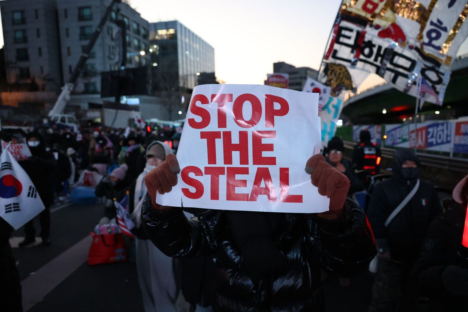 Supporters of South Korean President Yoon Suk Yeol during a protest near the presidential residence in Seoul, South Korea, on Wednesday, Jan. 15, 2025. South Korean investigators arrived at Yoon's residence on Wednesday morning in their second attempt to arrest the impeached leader over his short-lived martial law declaration. Photographer: Jean Chung/Bloomberg