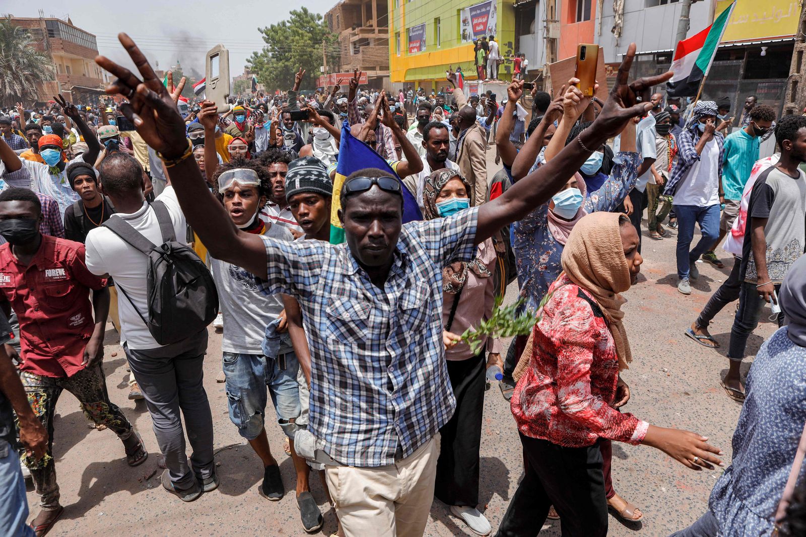 Anti-coup protesters chant slogans as they march during mass demonstrations against military rule in the centre of Sudan's capital Khartoum on June 30, 2022. - At least six Sudanese demonstrators were killed as security forces sought to quash mass rallies of protesters demanding an end to military rule, pro-democracy medics said. In one of the most violent days this year in an ongoing crackdown on the anti-coup movement, AFP correspondents reported security forces firing tear gas and stun grenades to disperse tens of thousands of protesters. (Photo by AFP) - AFP