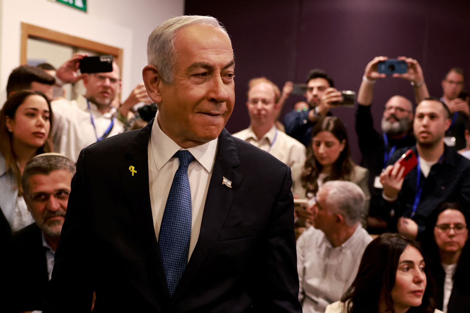 Israeli Prime Minister Benjamin Netanyahu arrives at the district court in Tel Aviv for his hearing on corruption charges on December 10, 2024. Netanyahu, the first sitting prime minister of Israel to face a criminal trial, testified for the first time when his corruption case resumed on December 10 on charges of bribery, fraud and breach of public trust in three separate cases.     MENAHEM KAHANA/Pool via REUTERS