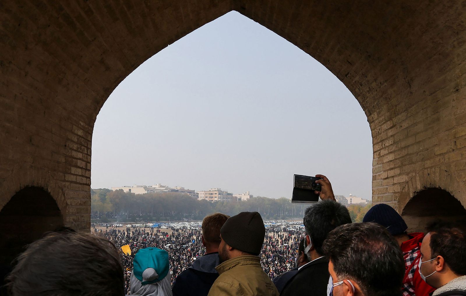 Iranians gather during a protest to voice their anger after their province's lifeblood river dried up due to drought and diversion, in the central city of Isfahan, on November 19, 2021. - The massive protest, that drew in farmers and other people from across Isfahan province, was the biggest since demonstrations over the water crisis started on November 9. (Photo by Fatmeh Nasr / ISNA / AFP) - AFP