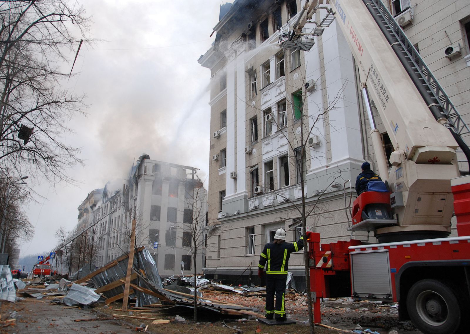 Firefighters work to extinguish fire in the damaged buildings of the Kharkiv National University and a regional police department in Kharkiv - REUTERS