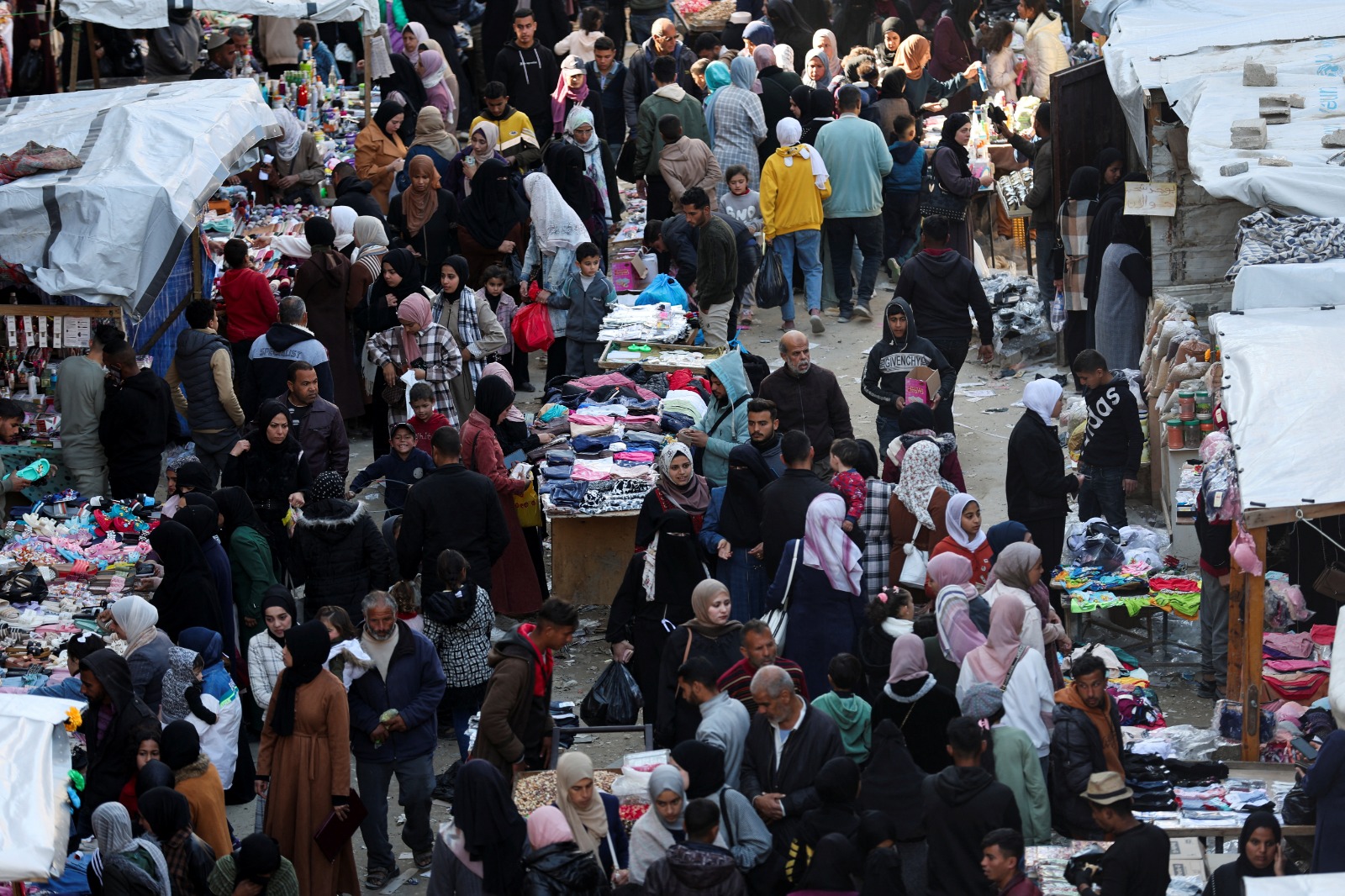 فلسطينيون يتسوقون استعدادا لشهر رمضان في خان يونس جنوب قطاع غزة.27 فبراير 2025