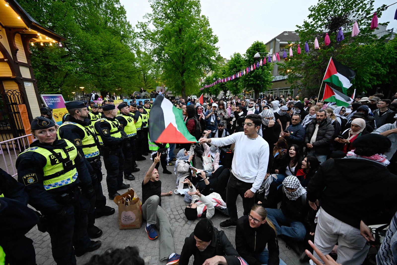 Pro-Palestinian protesters opposing Israel's participation in the 68th edition of the Eurovision Song Contest (ESC) in Malm� Arena face a wall of police outside Eurovision Village / Folkets Park in Malm�, Sweden, on May 9, 2024. This year's ESC competition has faced calls for Israel to be excluded over the war in Gaza, which the organisers refused. Thousands of people are expected to attend pro-Palestinian rallies throughout the week in Malmo. (Photo by Johan NILSSON / TT NEWS AGENCY / AFP) / Sweden OUT