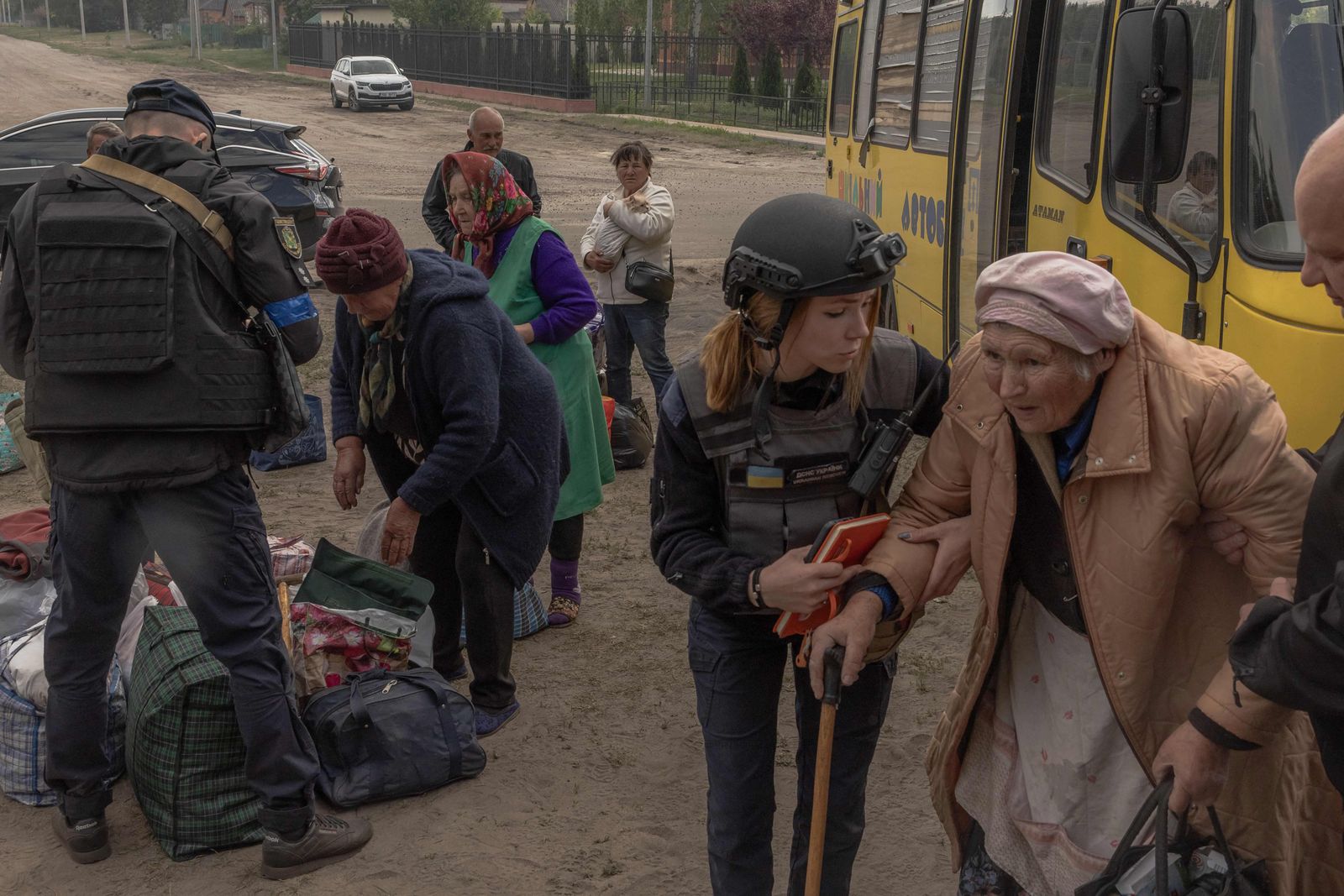 Evacuees from the arrive in a bus at an evacuation point in Kharkiv region, on May 12, 2024, amid the Russian invasion of Ukraine. Thousands of people have been evacuated from border areas in Ukraine's Kharkiv region, as Russia kept up constant strikes on a key town as part of a cross-border offensive, officials said on May 12, 2024. The surprise Russian attack across Ukraine's northeastern border began on Friday, with troops making small advances in an area from where they had been pushed back nearly two years ago. (Photo by Roman PILIPEY / AFP)