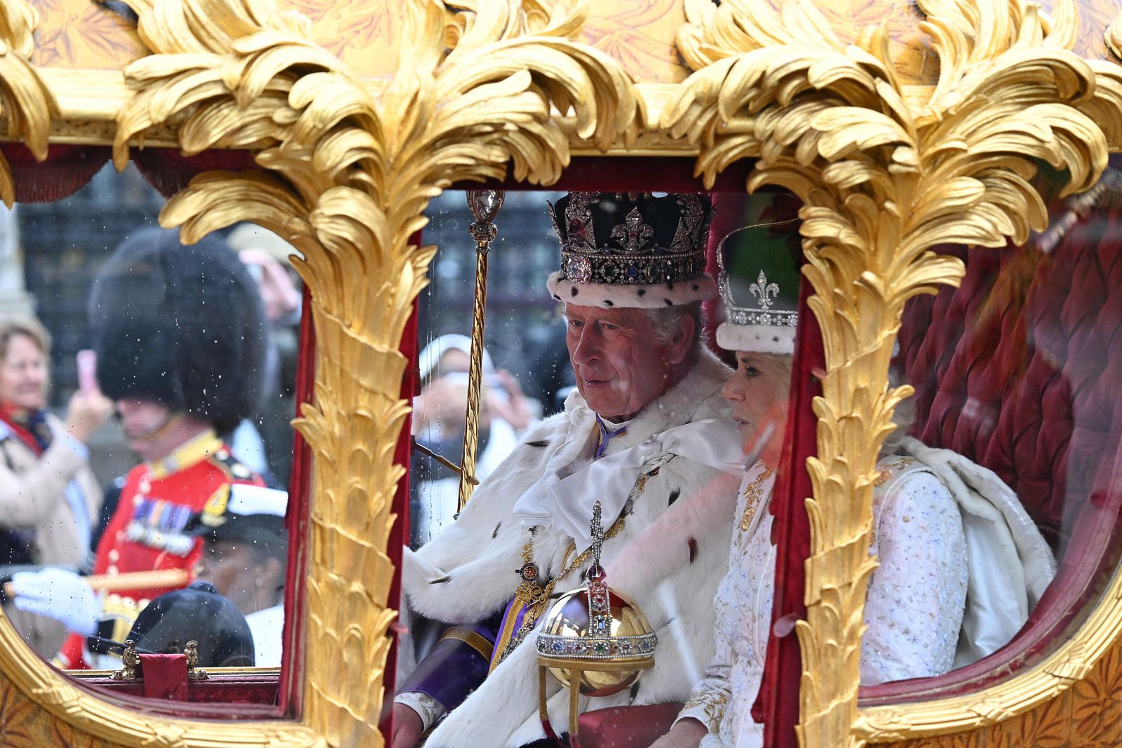 Britain's Queen Camilla and Britain's King Charles III travel in the Gold State Coach, back to Buckingham Palace from Westminster Abbey in central London on May 6, 2023, after their coronations. - The set-piece coronation is the first in Britain in 70 years, and only the second in history to be televised. Charles will be the 40th reigning monarch to be crowned at the central London church since King William I in 1066. Outside the UK, he is also king of 14 other Commonwealth countries, including Australia, Canada and New Zealand. Camilla, his second wife, was crowned alongside him, and will now be known as Queen Camilla. (Photo by Glyn KIRK / AFP) - AFP