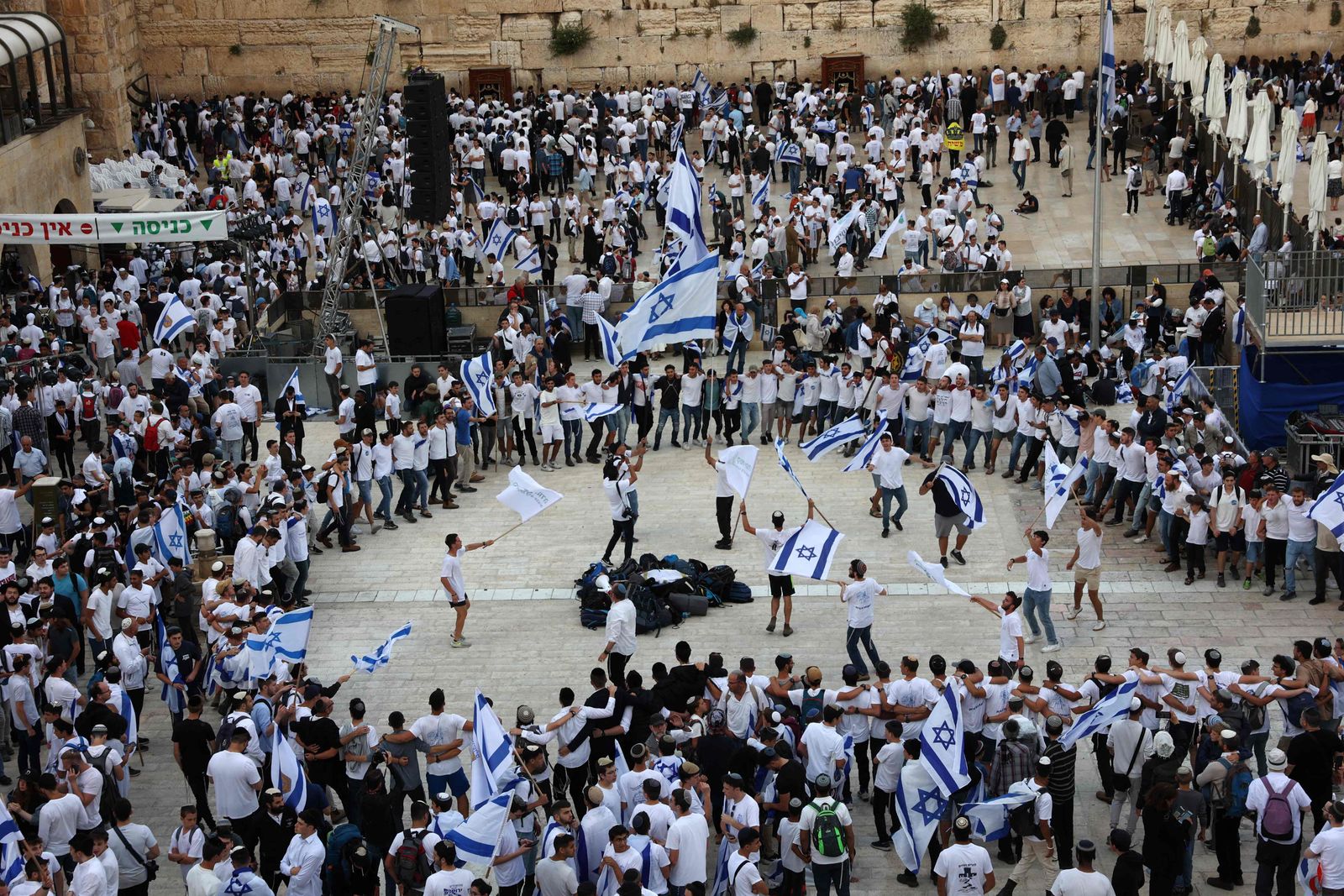 Israelis wave national flags as they gather at the Western Wall in the Old City of Jerusalem during the Israeli 'flags march' to mark 