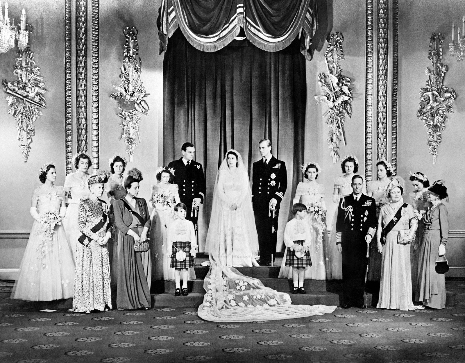 (FILES) In this file photo taken on November 20, 1947 members of the British Royal family and guests pose around Princess Elizabeth (future Queen Elizabeth II) (CL) and Philip, Duke of Edinburgh (CR) (future Prince Philip); at right the group includes Britain's King George VI (5R) stood next to Queen Elizabeth (3R) with Princess Alice of Athlone (R) and in front of bridemaids that include Princess Margaretb (7R) stood next to Philip; at left the group includes the best man David Mountbatten, Marquess of Milford Haven (7L) stood next to Princess Elizabeth, Mary of Teck (3L), mother of King George VI, stands at left in front of the bridesmaids next to Princess Alice of Battenberg (5L), Philip's mother; the page boys are Prince William of Gloucester and Prince Michael of Kent; in the Throne Room at Buckingham Palace on their wedding day. - Queen Elizabeth II, the longest-serving monarch in British history and an icon instantly recognisable to billions of people around the world, has died aged 96, Buckingham Palace said on September 8, 2022.  Her eldest son, Charles, 73, succeeds as king immediately, according to centuries of protocol, beginning a new, less certain chapter for the royal family after the queen's record-breaking 70-year reign. (Photo by AFP) - AFP