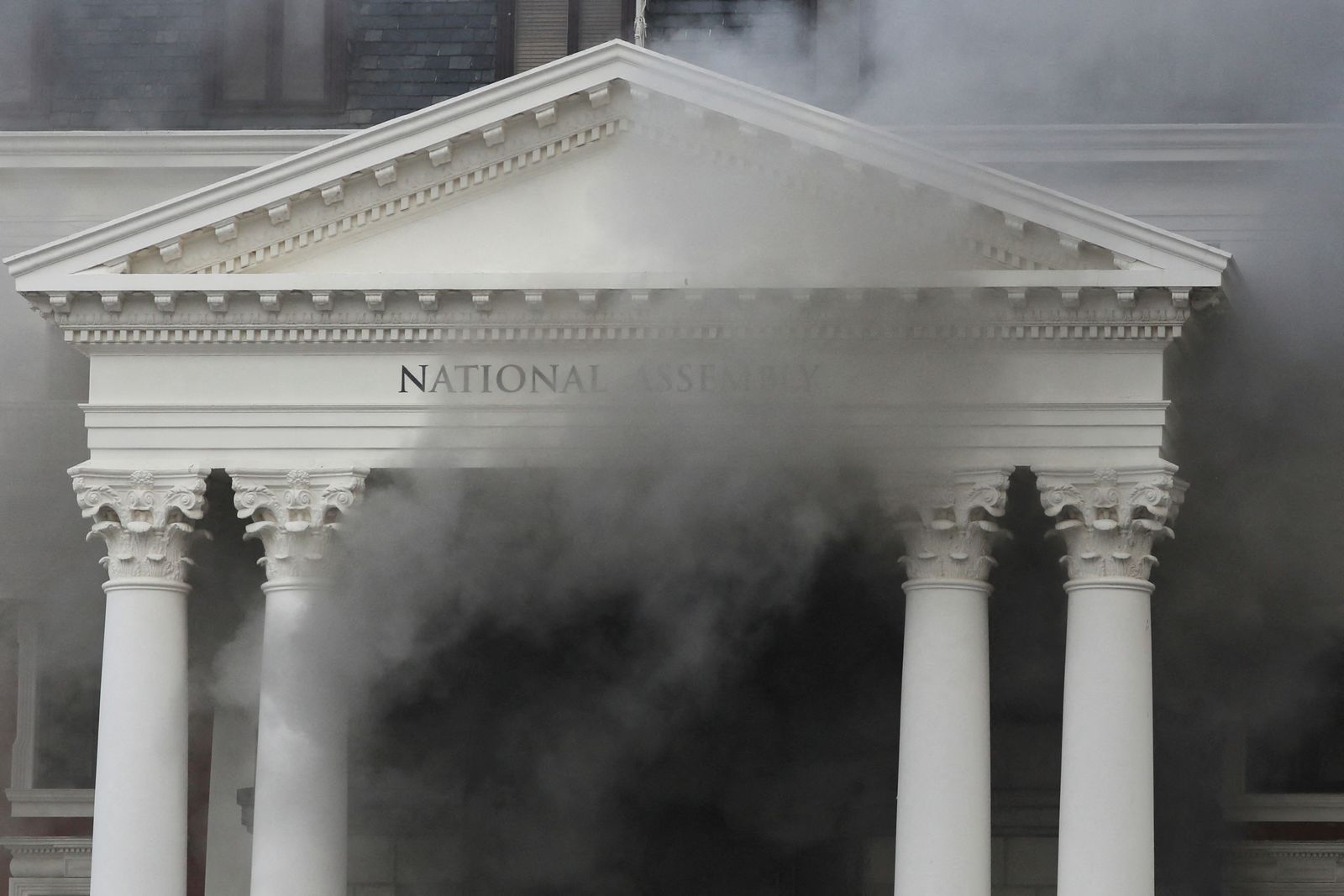 Smoke rises from the building of the Parliament in Cape Town - REUTERS