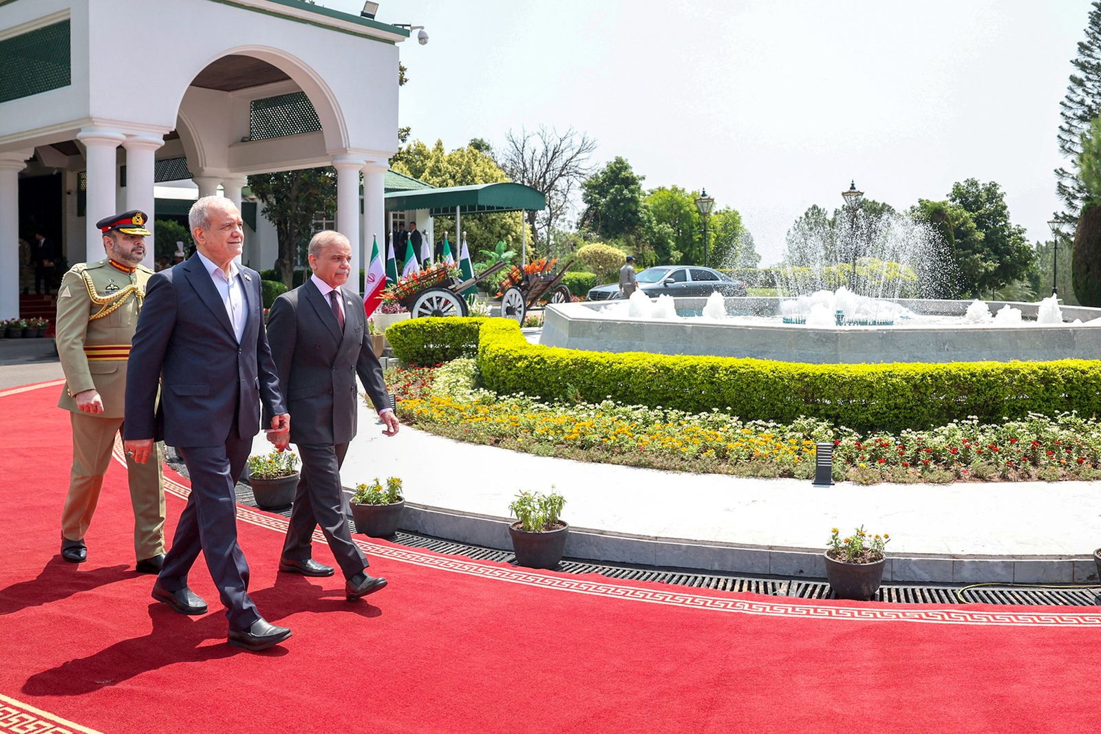 Iranian President Masoud Pezeshkian walks with Pakistani Prime Minister Shehbaz Sharif in Islamabad, Pakistan, August 3, 2025. Iran's Presidential website/WANA (West Asia News Agency)/Handout via REUTERS ATTENTION EDITORS - THIS PICTURE WAS PROVIDED BY A THIRD PARTY