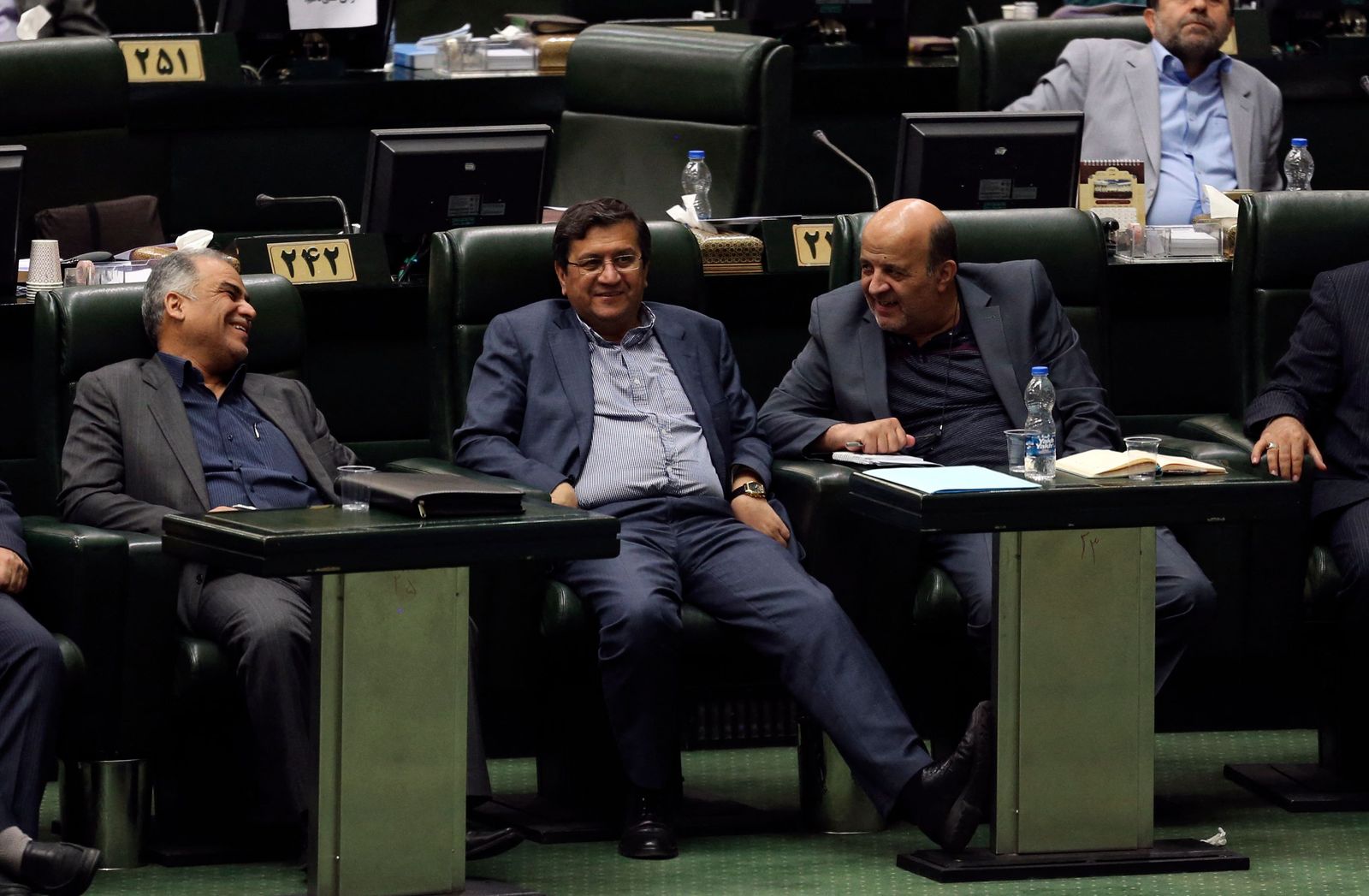 (FILES) In this file photo taken on October 7, 2018, Governor of the Central Bank of Iran Abdolnaser Hemmati (C) listens to a speech in parliament in Tehran. - Iran approved seven hopefuls to run in next month's presidential poll, with judiciary chief Ebrahim Raisi among the mainly ultraconservative candidates, while heavyweights Mahmoud Ahmadinejad and Ali Larijani were barred. (Photo by ATTA KENARE / AFP) - AFP