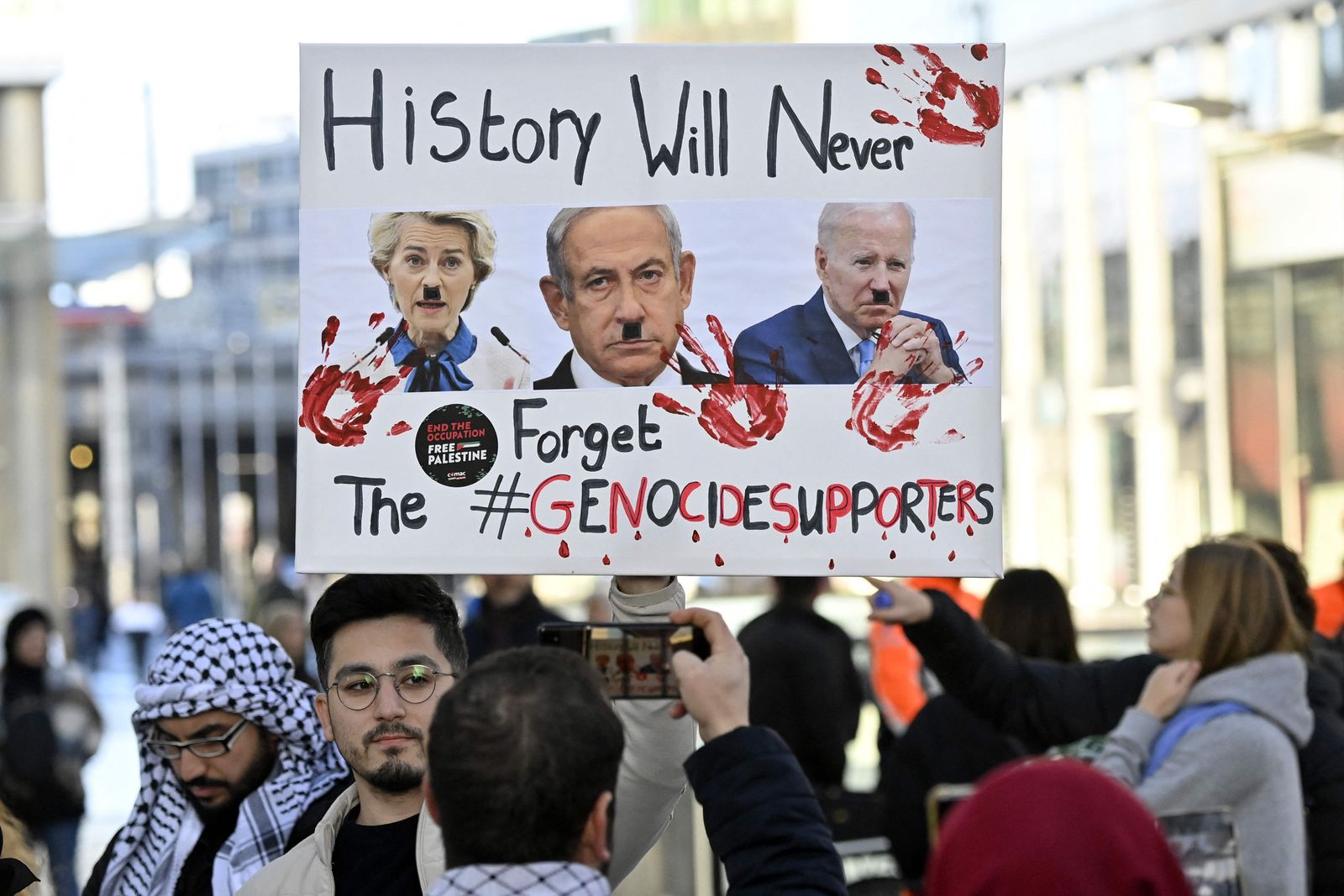 Protesters take part in a demonstration in support of Palestinians and to demand an immediate ceasefire in Gaza at Place de la Republique in Brussels, on November 11, 2023. Thousands of civilians, both Palestinians and Israelis, have died since October 7, 2023, after Palestinian Hamas militants based in the Gaza Strip entered southern Israel in an unprecedented attack triggering a war declared by Israel on Hamas with retaliatory bombings on Gaza. (Photo by JOHN THYS / AFP)