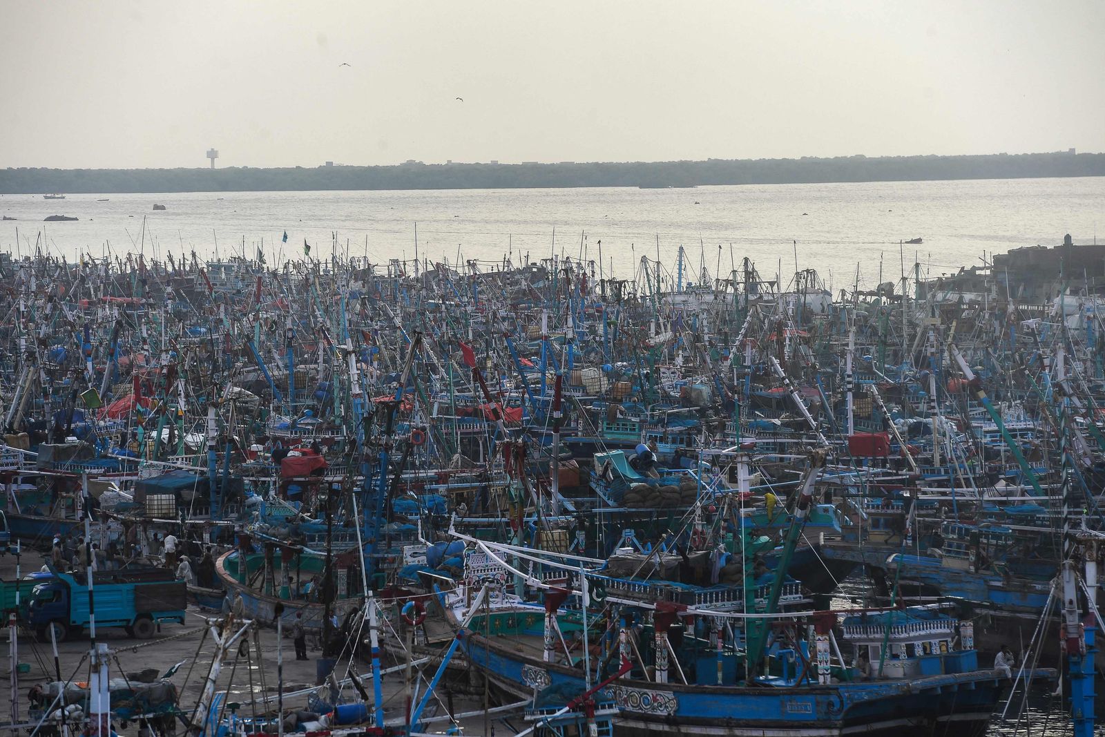 (FILES) In this file photo taken on September 29, 2021 fishing boats are anchored at the Karachi fish harbour after the Pakistani authorities issued an advisory to discourage fishermen venturing into the Arabian sea expecting bad weather conditions due to the cyclonic storm Gulab. - July 28, 2022 is the Earth Overshoot Day, the day in the year that humanity's ecological footprint exceeds Earth's resource production capacity. (Photo by ASIF HASSAN / AFP) - AFP