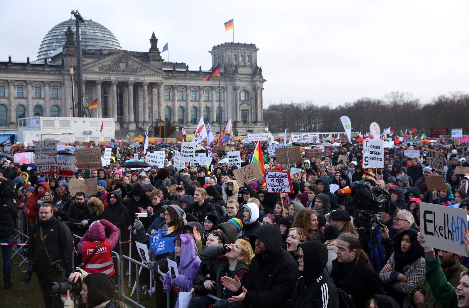 Demonstrators protest against the far-right Alternative for Germany (AfD) party outside the Reichstag building in Berlin, Germany on February 3, 2024, during a rally under the motto 'We are the firewall' called for by international non-profit organisation 'Hand in Hand' to protest against right-wing politics. Thousands of protesters gathered outside the Reichstag building in central Berlin to demonstrate against racism and the far right, with many more peaceful rallies planned across the country. (Photo by Adam BERRY / AFP)