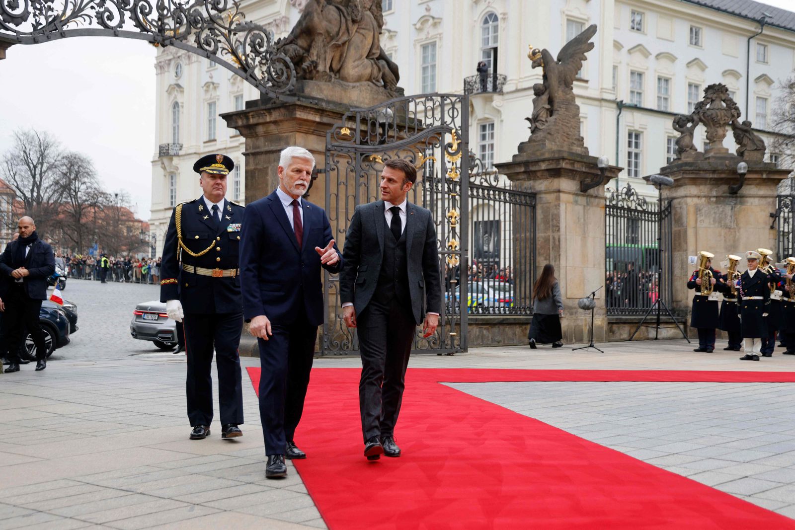 Czech President Petr Pavel (C) welcomes French President Emmanuel Macron (R) for his visit in front of the Castle in Prague, Czech Republic, on March 5, 2024. (Photo by Ludovic MARIN / AFP)