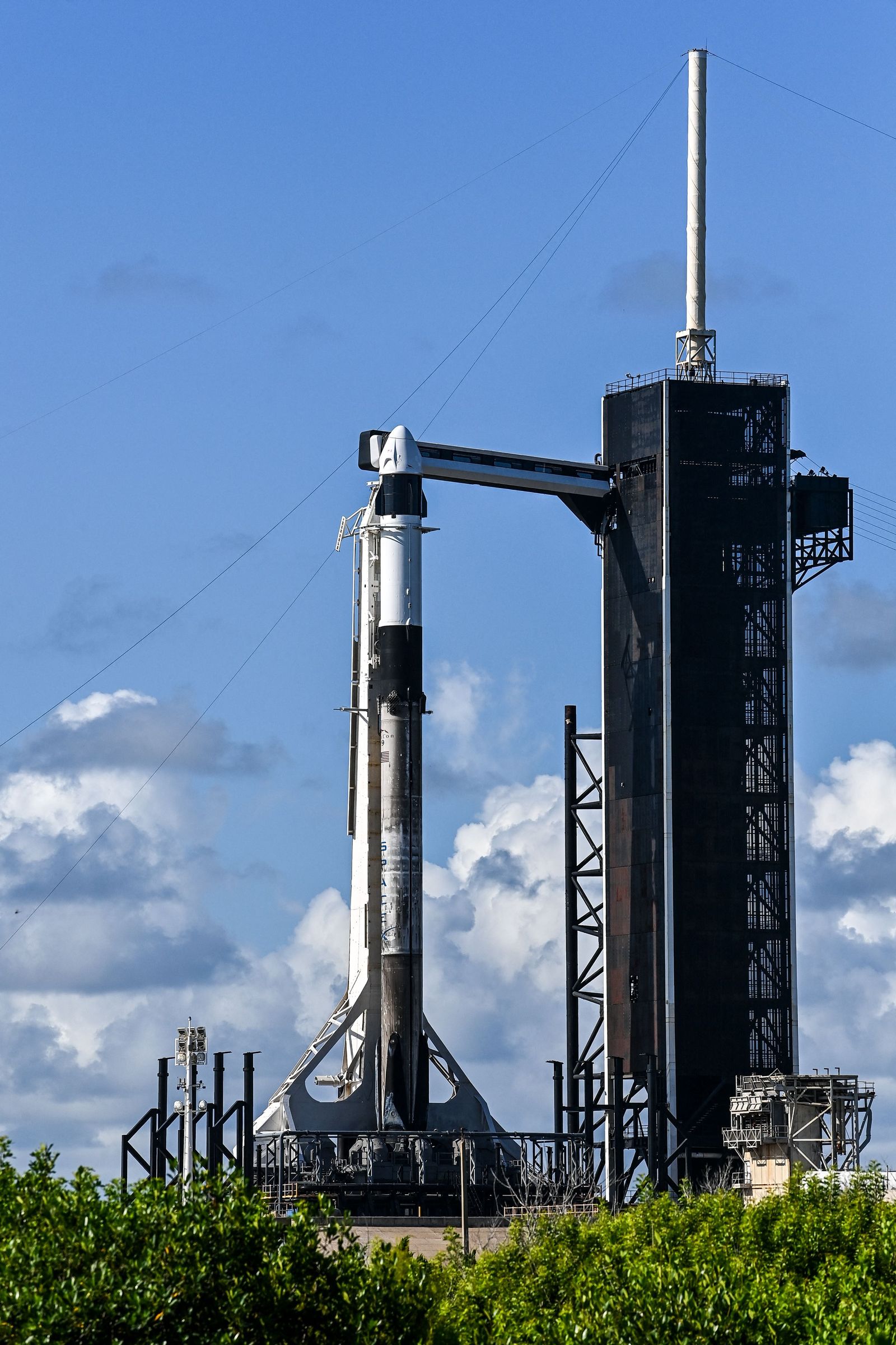 The SpaceX Falcon 9 rocket and Crew Dragon is seen sitting on launch Pad 39A at NASA�s Kennedy Space Center as it is prepared for the first completely private mission to fly into orbit in Cape Canaveral, Florida on September 15, 2021. - A Falcon 9 rocket, with a Dragon capsule at its top, will blast off from the legendary launch complex 39A at NASA's Kennedy Center in Florida, from where the Apollo 11 mission took off for the Moon. (Photo by CHANDAN KHANNA / AFP) - AFP