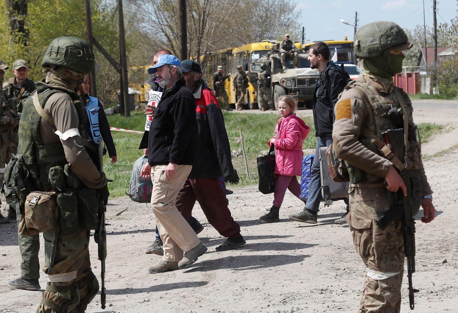 Civilians who left the area near Azovstal steel plant in Mariupol walk at a temporary accommodation centre in Bezimenne - REUTERS