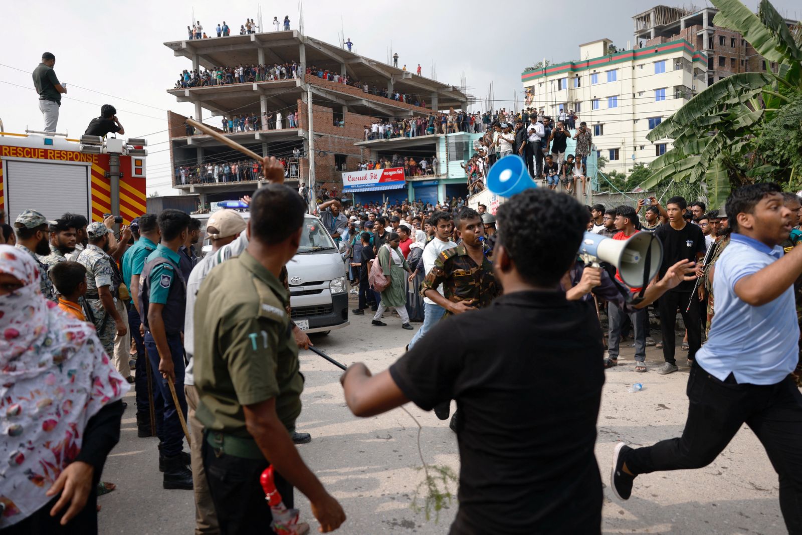 An ambulance carrying injured people comes out of the spot after an air force training aircraft crashed into Milestone College campus, in Dhaka, Bangladesh, July 21, 2025. REUTERS/Mohammad Ponir Hossain