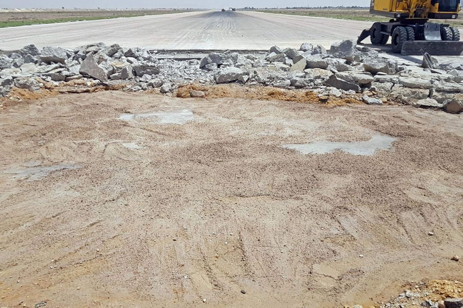 A handout picture released by the official Syrian Arab News Agency (SANA) on June 12, 2022 shows a runway damaged by an Israeli strike that caused the Damascus International Airport to shut down in the Syrian capital. (Photo by SANA / AFP) / == RESTRICTED TO EDITORIAL USE - MANDATORY CREDIT 