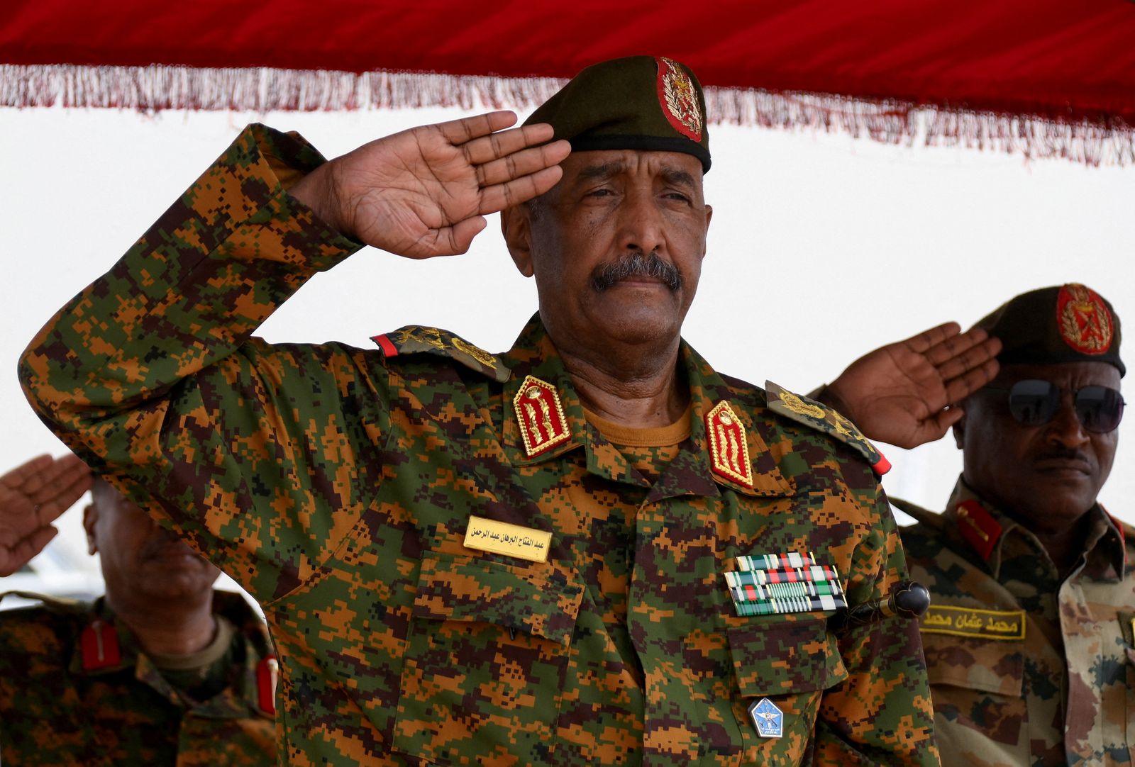 FILE PHOTO: Sudan's General Abdel Fattah al-Burhan salutes as he listens to the national anthem after landing in the military airport of Port Sudan on his first trip away following the crisis in Sudan's capital Khartoum since an internal conflict broke out, in the city of Port Sudan, Sudan, August 27, 2023. REUTERS/Ibrahim Mohammed Ishak/File Photo