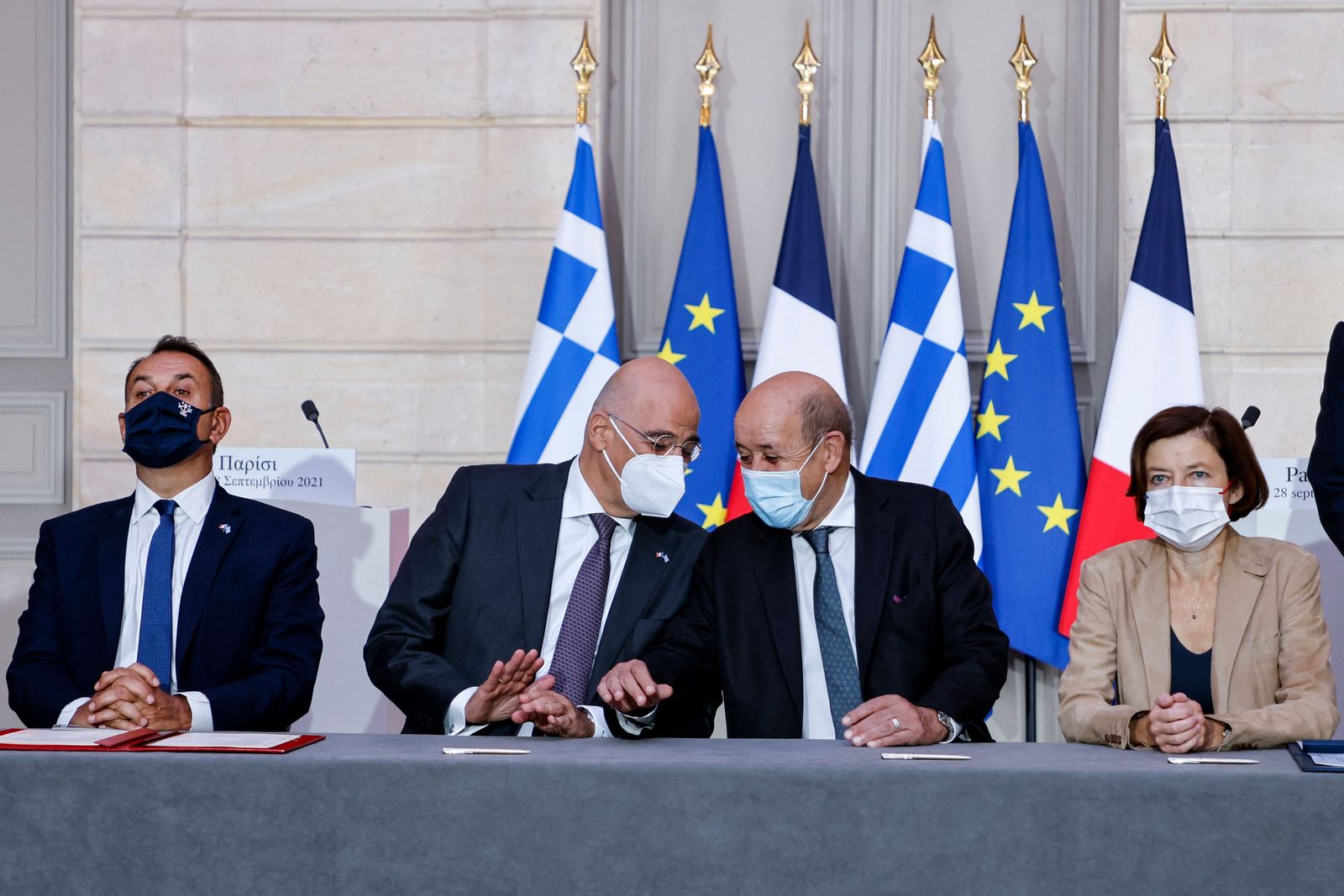 (fromL) Greek Defence Minister Nikolaos Panagiotopoulos, Greek Foreign Affairs Minister Nikos Dendias, French Foreign Affairs Minister Jean-Yves Le Drian and French Defence Minister Florence Parly take part in the signing ceremony of a new defence deal at The Elysee Palace in Paris on September 28, 2021. - Greece will buy three frigates from France as part of a deeper 