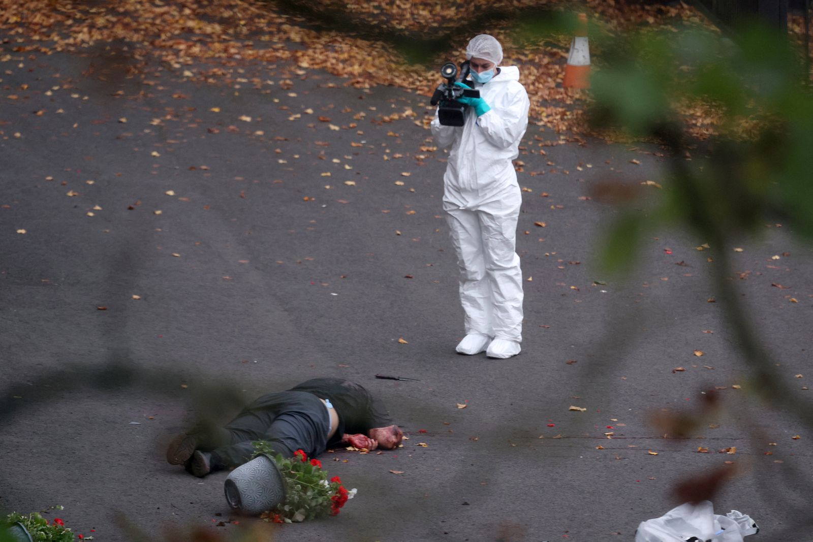 SENSITIVE MATERIAL. THIS IMAGE MAY OFFEND OR DISTURB    A forensic technician works near the body of a man, believed to be the attacker, at the scene, after a report of an incident in which a car was driven at pedestrians and a stabbing attack outside a synagogue, in north Manchester, Britain, October 2, 2025. REUTERS/Hannah McKay