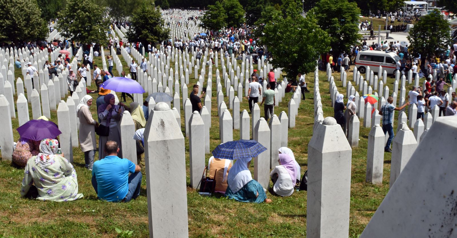 نساء من البوسنة يتجمعن خلال مراسم دفن توابيت مع رفات أقاربهن. 11 يوليو 2021 - AFP