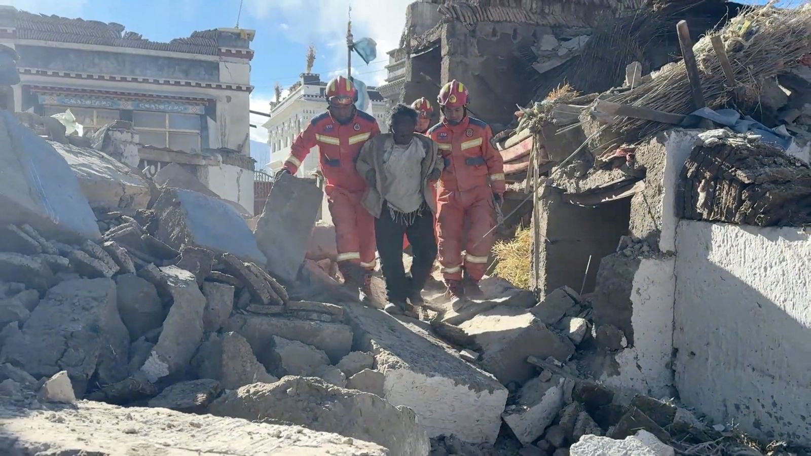 Members of a rescue team assist a casualty walk amidst rubble in the aftermath of an earthquake in a location given as Shigatse City, Tibet Autonomous Region, China, in this screengrab obtained from a handout video released on January 7, 2025. Tibet Fire and Rescue/Handout via REUTERS    THIS IMAGE HAS BEEN SUPPLIED BY A THIRD PARTY. NO RESALES. NO ARCHIVES. MANDATORY CREDIT