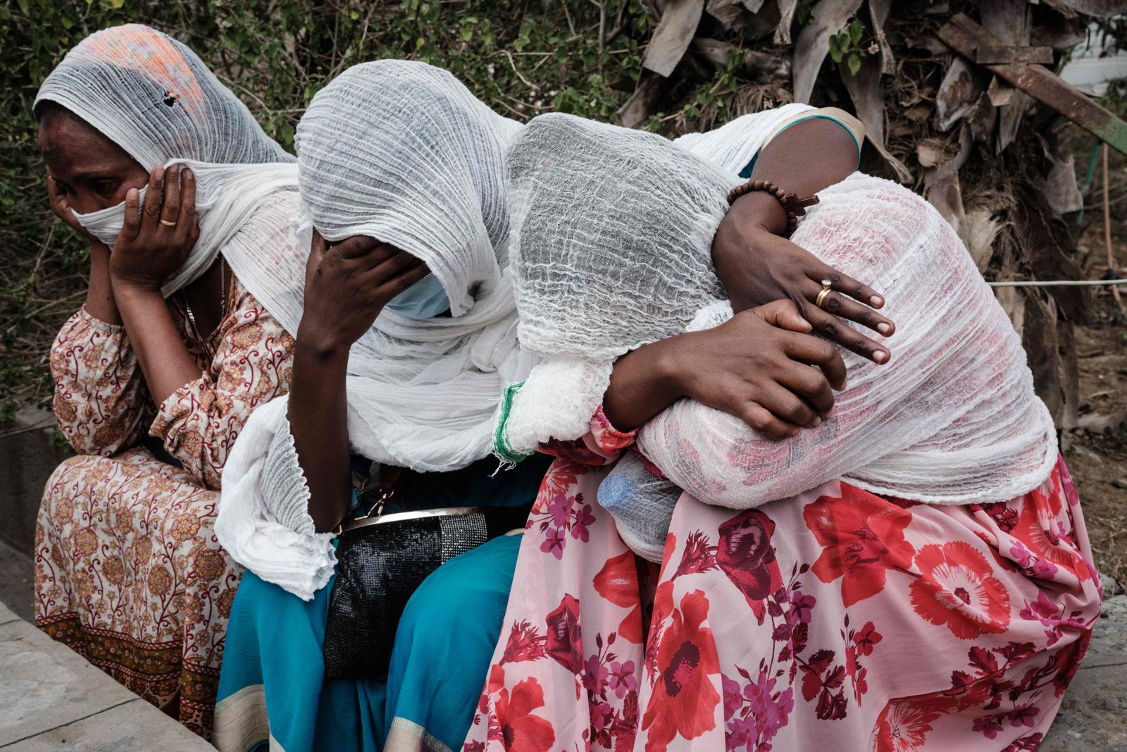 Relatives of Togoga residents, a village about 20km west of Mekele, where an alleged airstrike hit a market leaving an unknown number of casualties, wait for information as Red Cross ambulances are standing by after being denied access to the site, at the Ayder referral hospital in Mekele, the capital of Tigray region, Ethiopia, on June 23, 2021. (Photo by Yasuyoshi Chiba / AFP) - AFP