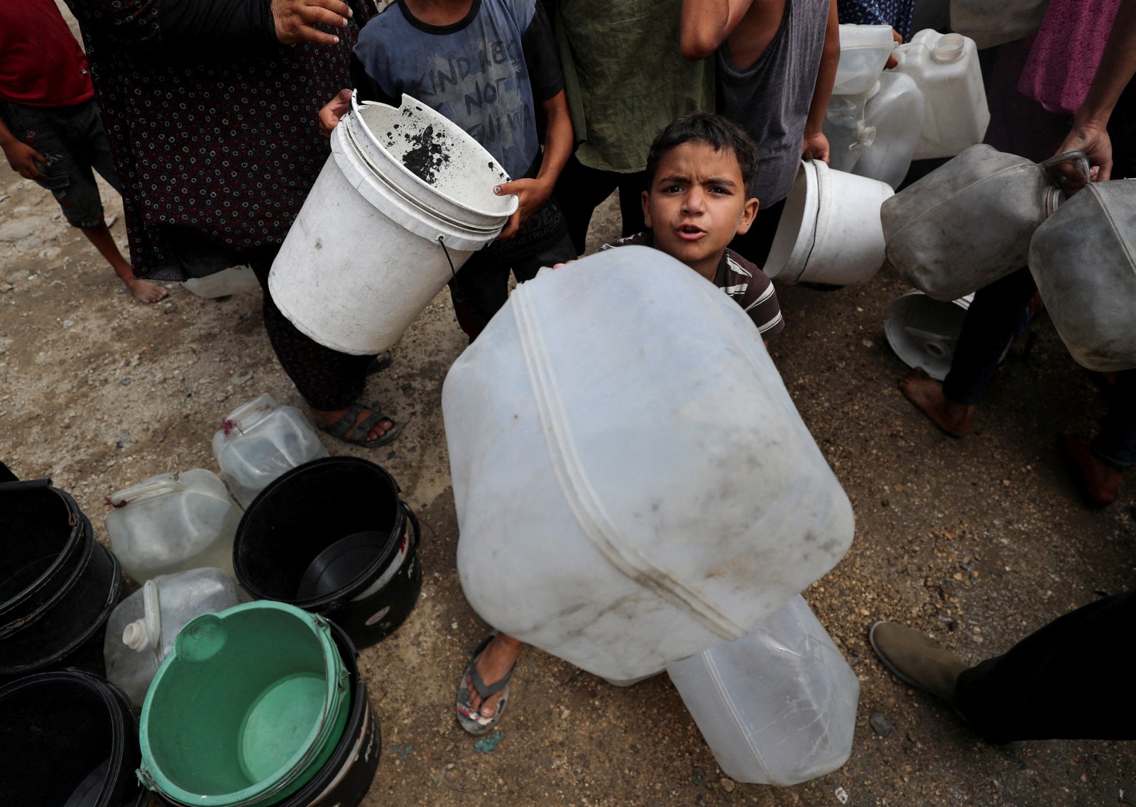 طفل فلسطيني نازح يحاول ملء مياه في مخيم داخل مدينة غزة، 1 أغسطس 2025